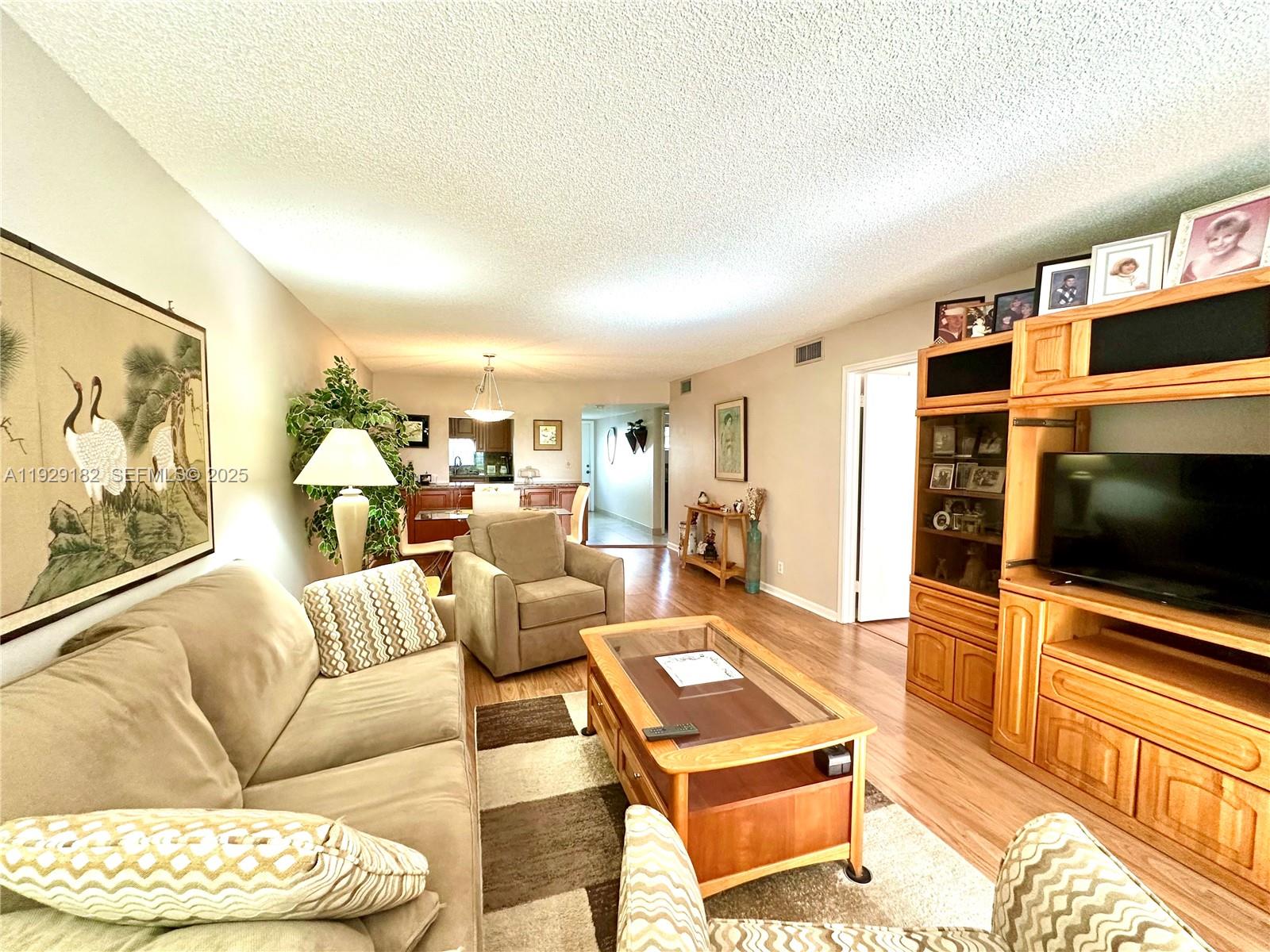 Enjoy relaxing garden  views from your screened in porch. The apartment is located on the first floor and features a spacious, updated kitchen with room for a small table, and updated bathrooms with tile and laminate floors through out.  Owners get to enjoy the resort style living with many amenities including one 18 hole executive golf course and one PGA 18 hole golf course for only $28. Golf carts also available.  Lots of amenities, including Club house, gym, multiple pools, tennis, pickleball, restaurant, BBQ/picnic area,  courtesy bus, heated pool,  sauna,  billiard room, shuffleboard, and more. The community is located close to shopping, dining, and highways for your convenience.