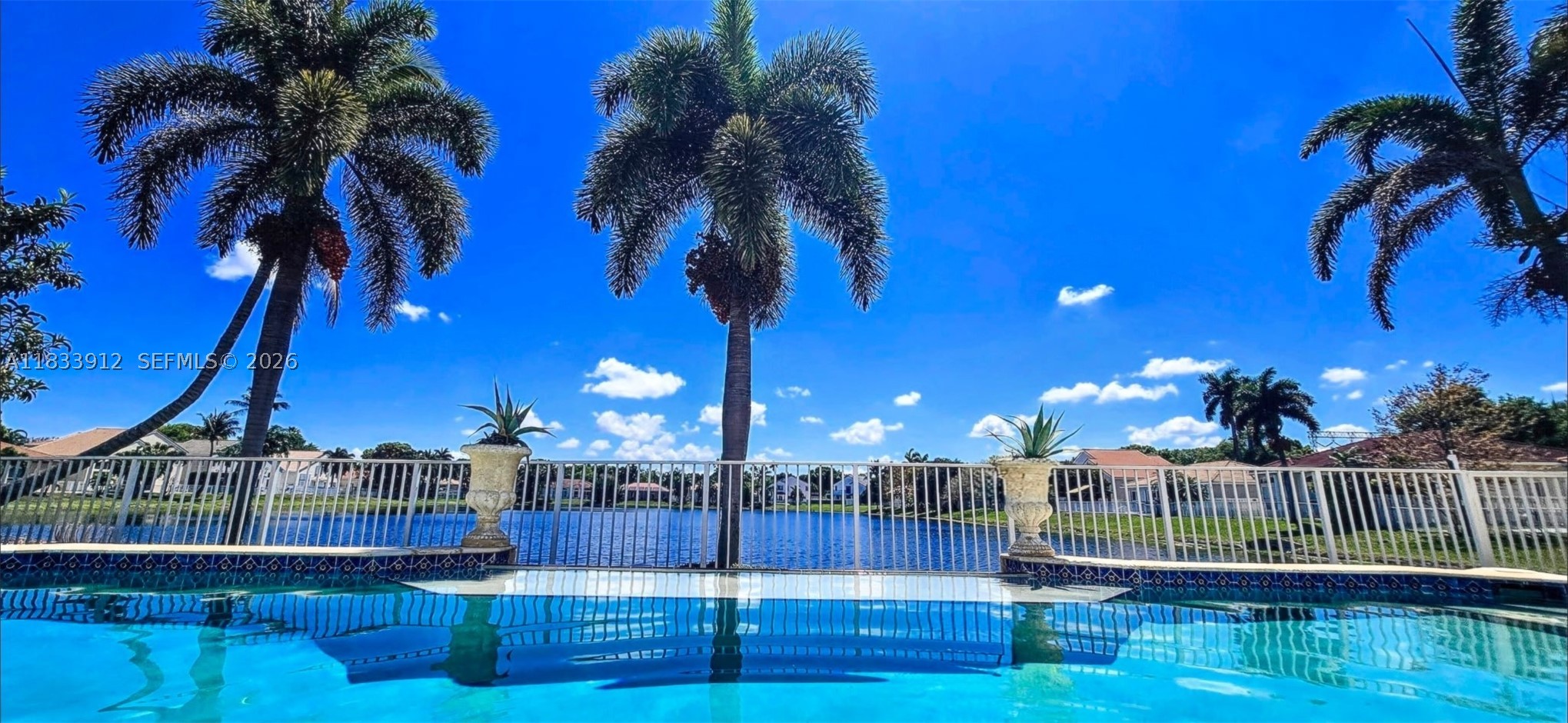 Exclusive Guard Gated Banyan Oakridge Community: Highly Desirable 3,652 Sq. ft. Home, With Spectacular Unobstructed Wide & Deep Lake Views ! Resort Style Infinity Pool. Rarely Available Lakefront Lot! Plenty Of  Privacy. Completely Redesigned With Exquisite Taste, 5 Bedrooms, 3.5  Bathrooms, Plus Additional 1st Fl. Room, Can be a 6th Bedroom! Building Apx. 3652 Sq. Ft.  Featuring Jerusalem Stone Flooring, Hi Impact Patio French Doors, Hi Impact Glass, Newer Roof 2024, Tiki Hut W Electric, Extra Wide Infinity Style Pool,W Sundeck And Much More. Amenities Include Excellent Tennis Courts, Basketball Court, Tot Lot, All Within Very Close Proximity To Many  Houses Of Worship, I95,595, Fl. Turnpike,  Airport, Seaport, Hard Rock Casino, Downtown Hollywood, And The Beaches!