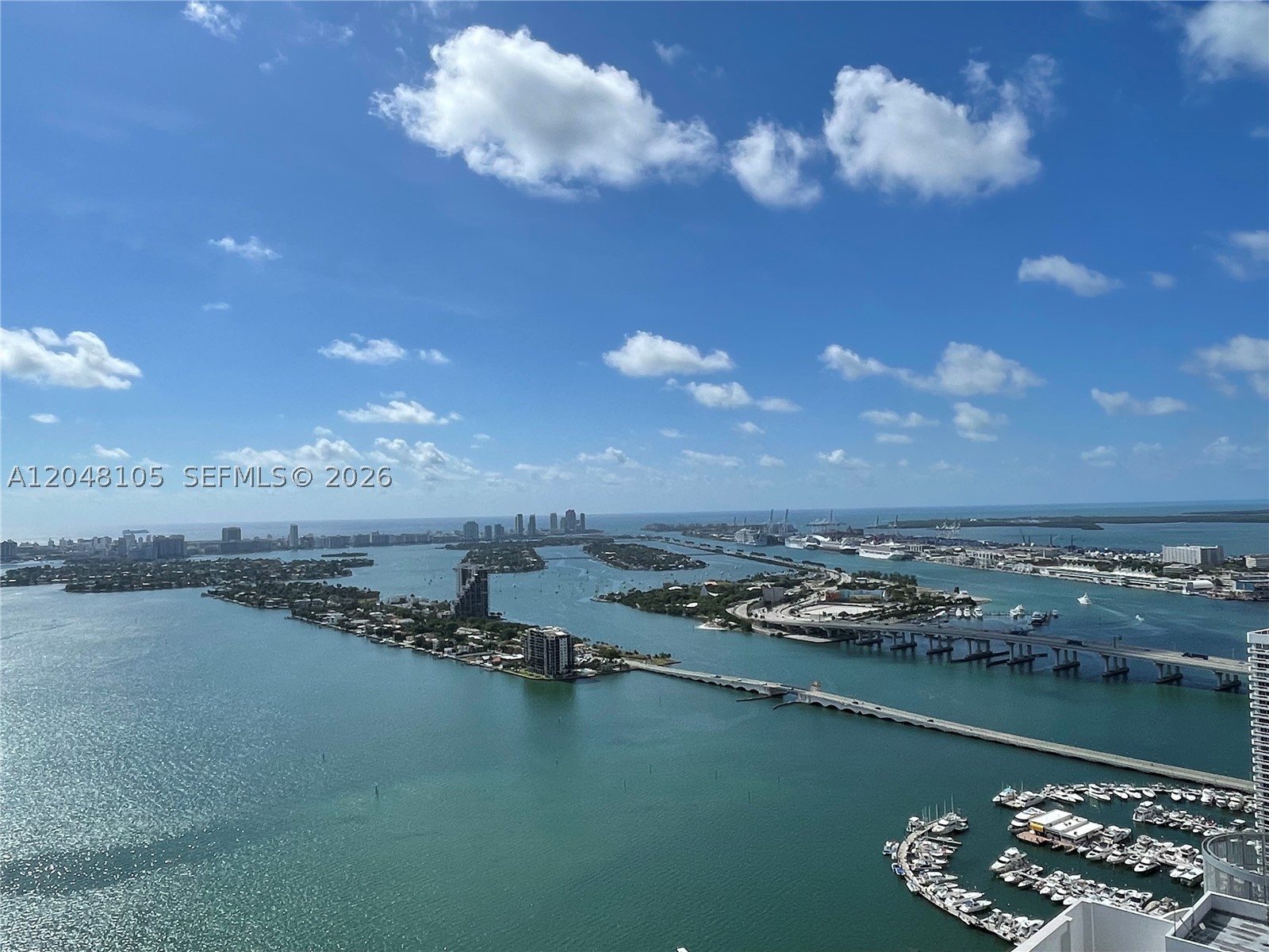 Experience elevated living from the 50th floor of Quantum on the Bay. This exceptional 2bed/ 2 bath residence offers a bright, open-concept floor plan with a modern kitchen overlooking the spacious living and dining areas, ideal for both entertaining and everyday living.
Floor-to-ceiling impact glass showcases breathtaking panoramic views of Biscayne Bay, Miami Beach, the Atlantic Ocean, and spectacular sunsets and sunrises. Two balconies provide the perfect setting to enjoy Miami's ever-changing skyline and waterfront scenery.
The luxurious primary suite is a true private retreat, seamlessly blending bedroom and spa. Wake up to incredible city views and unwind in the stunning open-concept bathroom featuring a sculptural freestanding soaking tub, oversized walk-in glass shower, illuminated backlit onyx feature wall, and designer finishes that create a tranquil, resort-inspired atmosphere unlike any other. The secondary bedroom offers comfort and flexibility for guests or a home office.
This residence also includes two assigned parking spaces, a rare and highly desirable feature at Quantum. Residents enjoy resort-style amenities including two swimming pools, a state-of-the-art fitness center, theater, club rooms, business center, convenience store, 24-hour concierge, valet, and secure lobby. Perfectly located across from Margaret Pace Park and just minutes from Wynwood, the Design District, Brickell, Downtown Miami, Miami Beach, and world-class dining and entertainment.