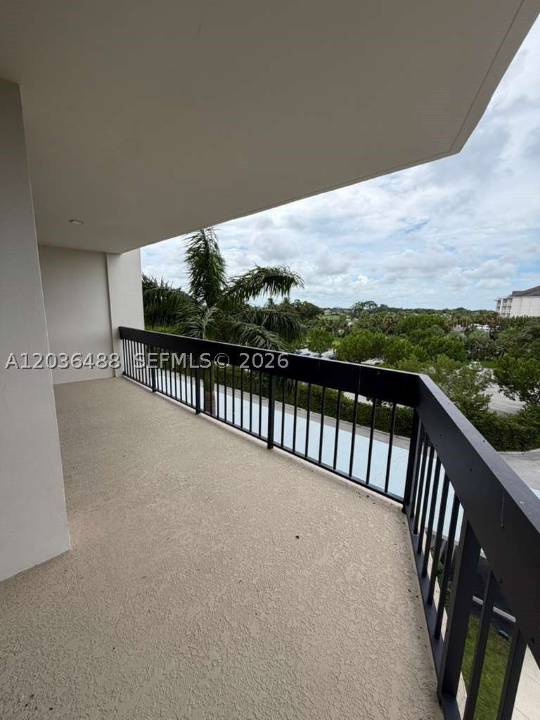 Remodeled 2-bedroom, 2-bath condo in the gated Lands of the President community in West Palm Beach. This 1,294 sq ft residence features tile and wood flooring, an open kitchen with breakfast bar, smooth ceilings, updated lighting and fans, glass shower doors, newer A/C, and an in-unit washer and dryer. The convertible second bedroom with shoji-style sliding doors offers flexibility for guests, office space, or everyday living. Enjoy golf and pool-area views from two balconies, plus building amenities including a pool, exercise room, community room, bike storage, doorman service, and guard-gated entry. Convenient location near Palm Beach Outlets, CityPlace, beaches, dining, shopping, and major roads.