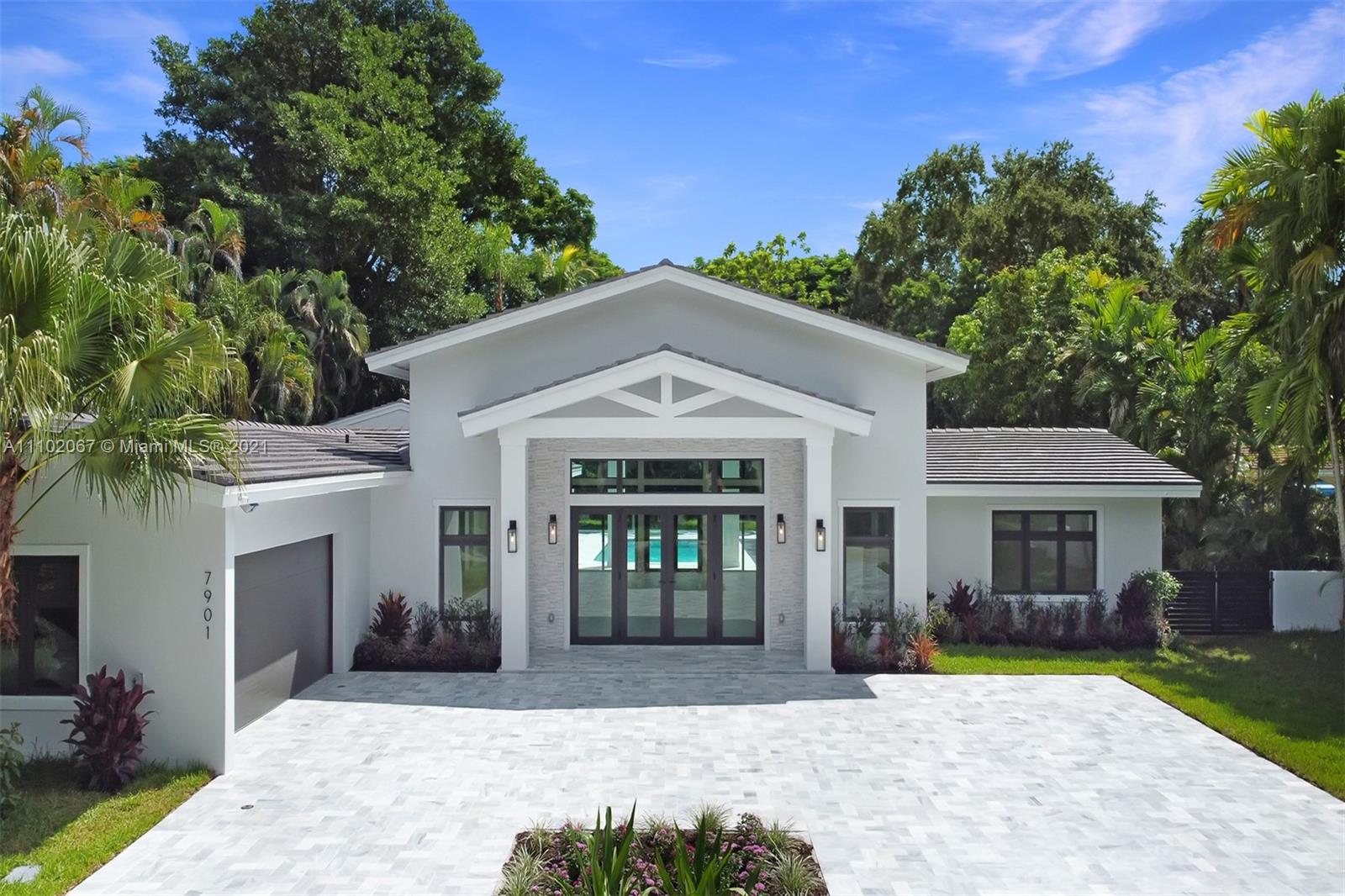 Spectacular 1-story estate located in Coral Gables' Platinum Triangle. Offers soaring ceilings, 6 beds, 7½ baths, and is nestled on a 20,000 sf lot surrounded by lush tropical gardens and mature trees. This 5,267 adj. sf (6,290 total sf) residence was fully gutted and rebuilt in 2021. Everything is new: roof, floors, walls, impact windows, plumbing, electrical, HVAC, septic tanks, kitchen, laundry room, baths, and driveway. Featuring a top-of-the-line kitchen with huge island, Sub Zero and Wolf appliances, wet bar, breakfast area, and walk-in pantry. The luxurious main suite has a sitting area, his and hers walk-in closets, a spa like bath with double showers and a floating tub. The heated resort style pool and spa, summer kitchen, and shaded outdoor terraces are perfect for entertaining.