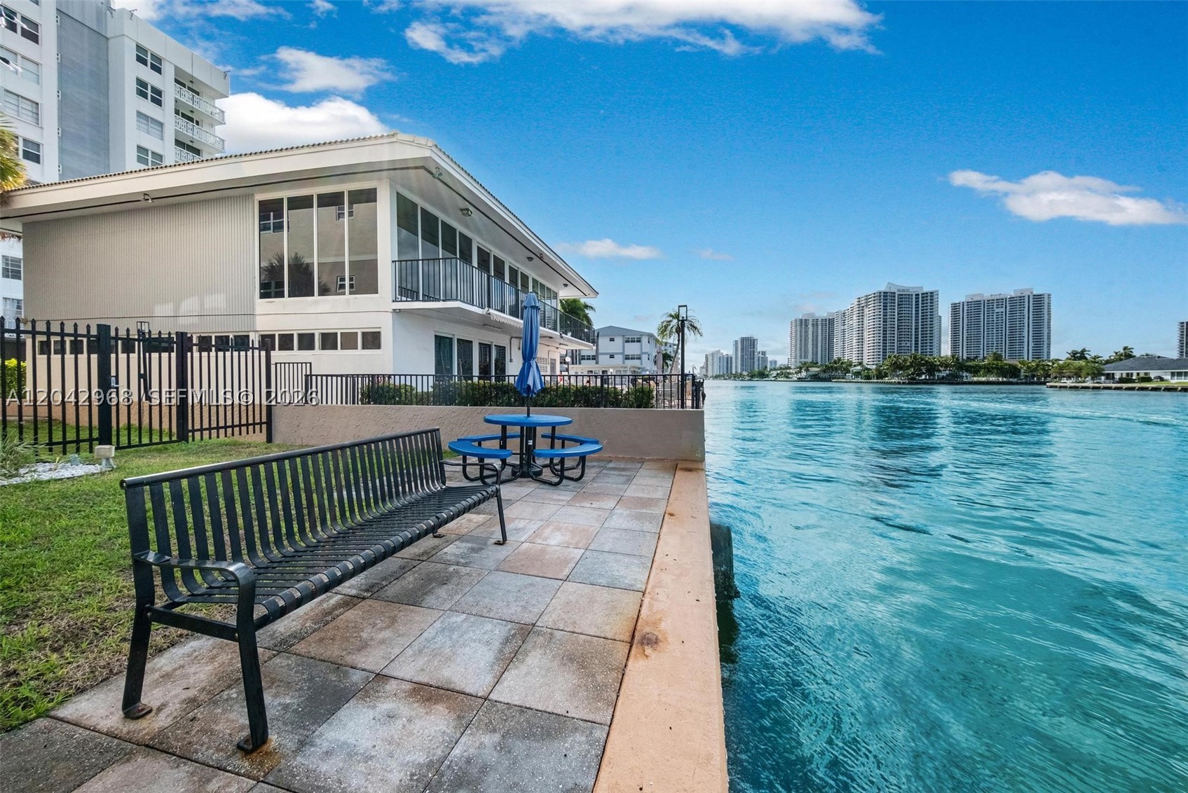 Completely remodeled 2-bedroom, 2-bath corner unit in a boutique waterfront building on the Intracoastal, just a short walk to the beach. This bright 1,139 SF residence features a renovated kitchen with stainless steel appliances, updated bathrooms, spacious bedrooms, ample closet space, and a private balcony with garden, pool, and partial water views. Assigned covered parking space. Waterfront pool and landscaped grounds. Conveniently located near shopping, restaurants, houses of worship, and golf courses. Move-in ready and ideal as a primary residence, second home, or seasonal getaway.