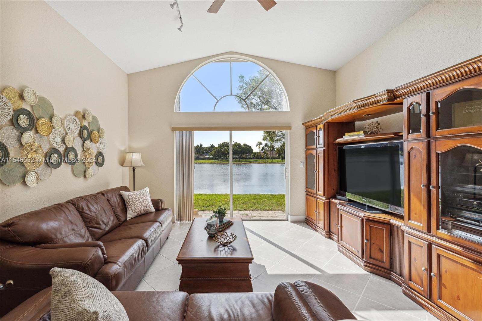 Amazing single family lakefront view in an elegant Lakes by the Bay gated community! This 3 Bedroom, 2 Bathroom house includes a full 2 car garage, a tall double door entrance, tile floors throughout the house, vaulted ceilings, a living room, formal dining, and an open kitchen concept with a clear view of the lake, while featuring stainless steel appliances with a large pantry. The laundry room includes a washer and dryer and provides easy access to the garage with hurricane shutters and plenty of storage space. The master bedroom includes 2 large walk-in closets, double sink, shower, and a jacuzzi tub. The guest rooms include ample space for king beds. The HOA provides a gorgeous clubhouse, ample parking, lake view, pool, playground, gym and front lawn maintenance for residences as well.