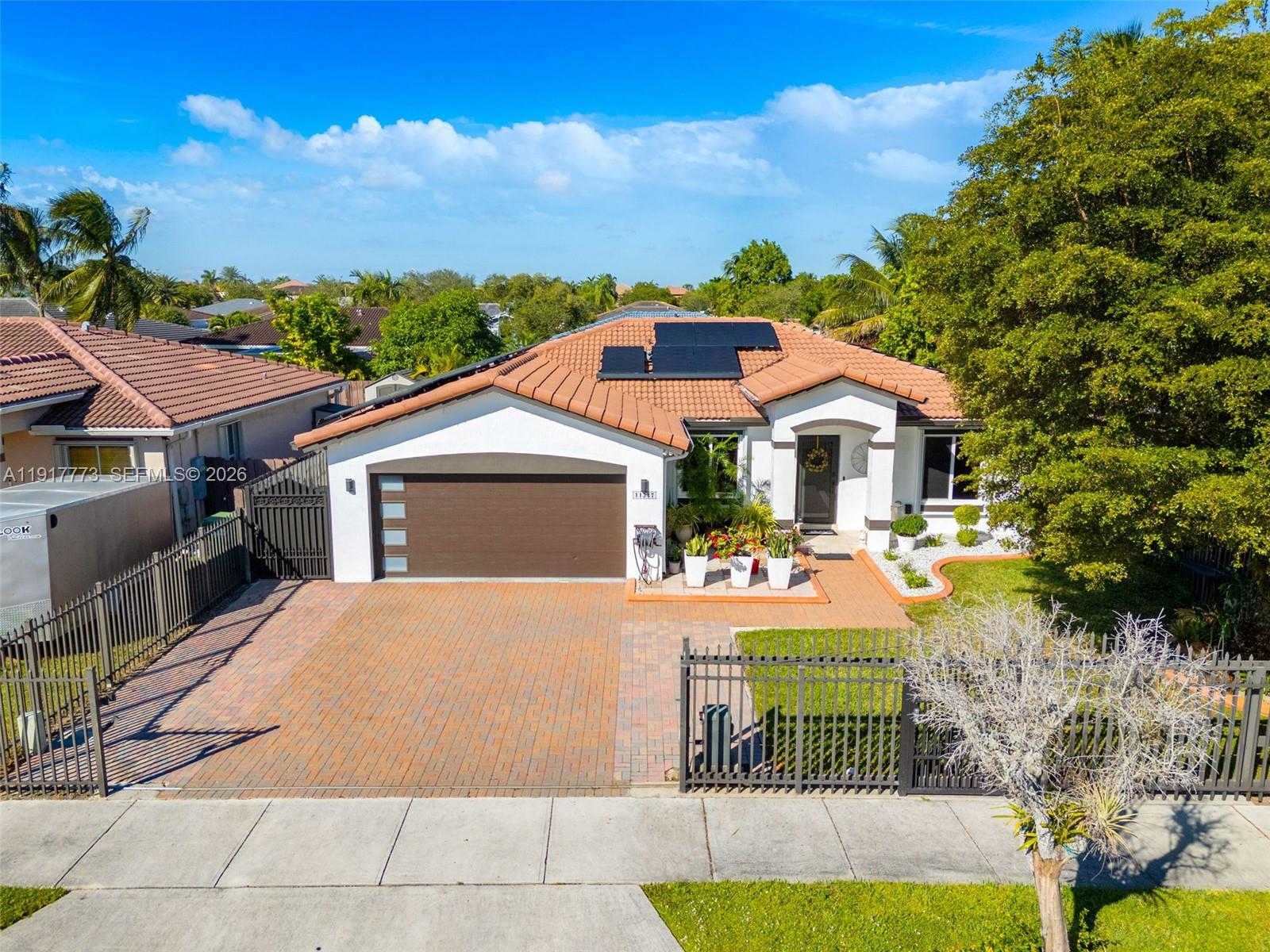 Immaculate and move-in ready, this stunning home in the highly sought-after Islandia at Black Point Marina community offers the perfect blend of comfort, style, and peace of mind. Featuring 3 spacious bedrooms, 2 immaculate bathrooms, and a charming barrel tile roof with no HOA or CDD, this property delivers exceptional value. Enjoy major savings and year-round efficiency with solar panels, a backup battery, and an on-demand water heater. The home is fully protected with impact windows and doors, reinforced accordion shutters, an alarm system, and surveillance cameras. A 2-car garage provides ample space and convenience. Step outside to your beautifully finished outdoor retreat with an enclosed patio, artificial turf, paved driveway, and gutters, offering low maintenance living at its best. Ideally located just minutes from Black Point Marina and the Florida Turnpike, this home is an incredible opportunity for buyers seeking quality, convenience, and modern upgrades all in one.