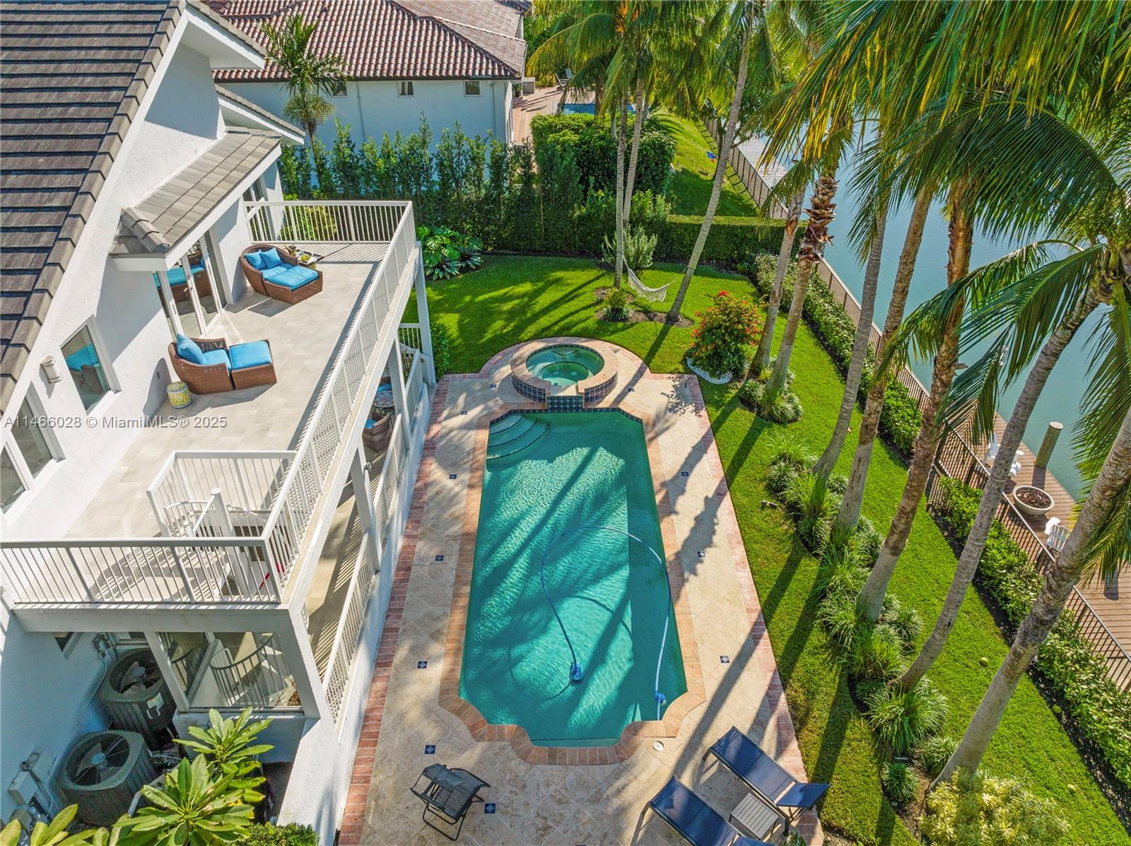 Welcome to your dream waterfront home in Gables by the Sea, a prestigious gated community offering tranquility and luxury. This stunning 2-story residence has been impeccably renovated with top-tier finishes, seamlessly blending sophistication and serenity. Soaring ceilings and Porcelanosa floors frame breathtaking water views. The primary suite boasts high ceilings, adding a sense of space and flooding the room w/ natural light, while the private balcony overlooks lush tropical gardens and peaceful waterfront vistas. Relax in the Jacuzzi, cascading into a sparkling saline-chlorine pool. The gourmet kitchen, featuring a grand quartzite island and Thermador & Wolf appliances, is a chef’s delight. Every gorgeous sunset feels magical in your private oasis—resort-style living at its finest