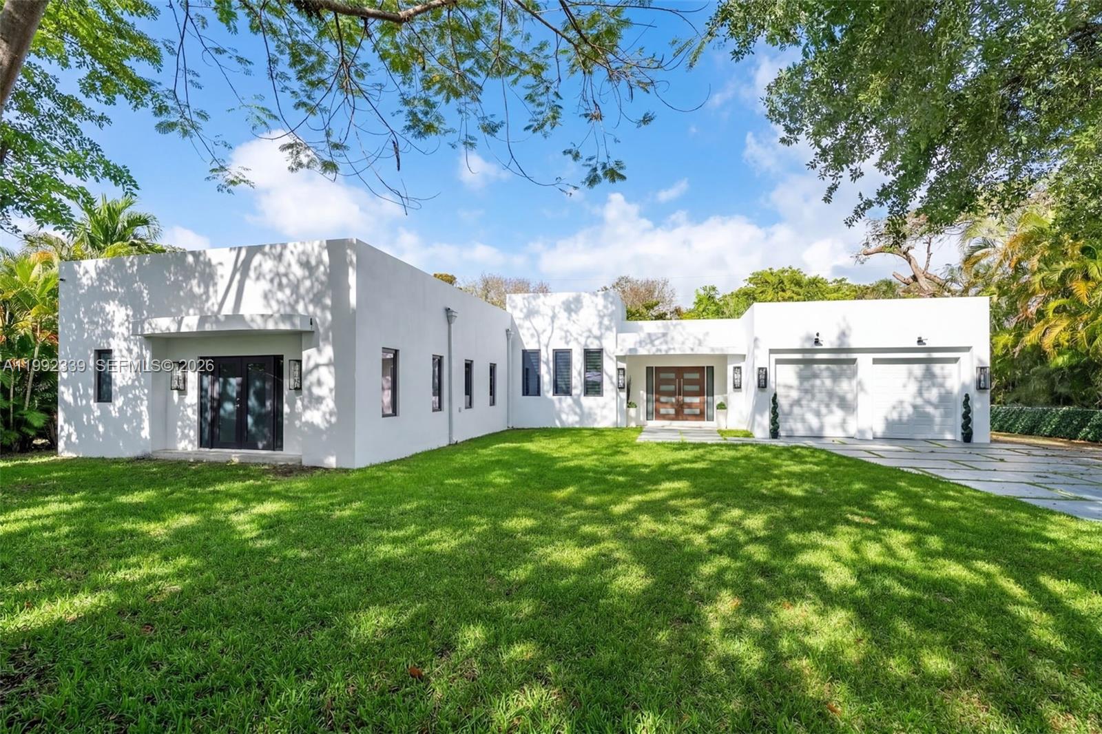 Fully gated and completely rebuilt in 2022, this modern home offers privacy, style, and contemporary design throughout. The sleek kitchen is designed for both everyday living and entertaining, featuring quartz countertops, a large island, ample storage, and high-end Bosch appliances. The spacious primary suite offers access to the front yard, a large walk-in closet with custom built-ins, and a spa-like bathroom with dual sinks, a soaking tub, and a separate shower. Featuring 4BD/4BA, the flexible layout includes one bedroom currently used as a home office. Enjoy a private back patio with low-maintenance artificial turf, perfect for relaxing or entertaining. Additional highlights include a welcoming foyer with a sitting area, a laundry/utility space in the two-car garage. Gate, garage, and sprinklers can be conveniently controlled from your phone, completing this turnkey modern home.