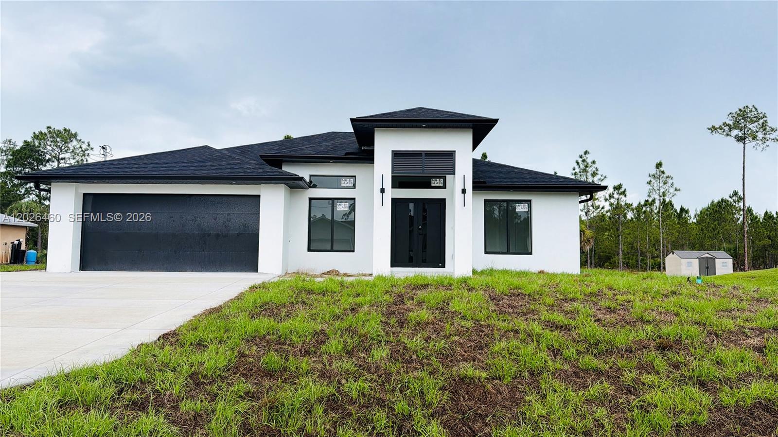 Experience modern living in this beautifully designed 4-bedroom, 2-bathroom home offering 1,650 sqft of open-concept living space on a spacious 0.50-acre lot. Featuring elegant porcelain tile floors throughout, this home showcases a sleek contemporary style with acrylic kitchen cabinetry, luxurious marble countertops, and stainless steel appliances. The spacious layout includes a versatile first bedroom ideal for a den, office, or guest room. The large master suite offers a private retreat with a double-sink vanity and beautifully designed bathroom with shower. A dedicated laundry room with additional storage cabinets adds convenience and functionality. The attached 2-car garage features independent doors with private access, providing excellent potential for a future efficiency, game room, or additional living space. Outside, enjoy additional parking with an oversized driveway accommodating 4–6 extra vehicles, plus plenty of room for RVs, boats, or a future pool. Enhanced exterior lighting adds style and security to this exceptional property. Perfectly combining comfort, modern finishes, and endless possibilities, this home is ideal for families, entertaining, or investment opportunities. Do not wait to see this gem! Call now and make your showing appointment!