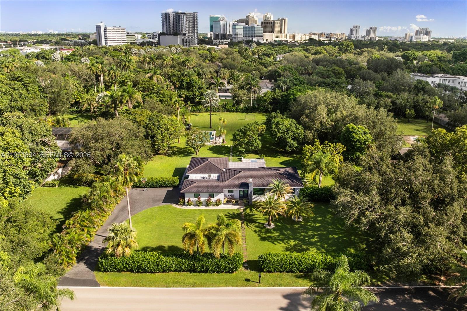Set on over an acre in prestigious North Pinecrest, this exceptional property offers an increasingly rare opportunity to secure a park-like estate in one of the area’s most desirable and established residential neighborhoods, known for its estate properties, privacy, and top-tier schools. The grounds feature mature tropical landscaping, select fruit trees, and expansive open lawns, creating a serene setting and an exceptional sense of space, making it an ideal canvas for a future custom estate.

Zoning allows for a secondary structure, enabling the addition of a guest house, home office, or other complementary use in support of the main residence. Existing infrastructure, including a natural gas connection, a full-house gas generator capable of supporting a larger residence, and an already-installed municipal water connection, adds meaningful value for future planning.

The existing residence is light-filled and functional, offering flexibility while a future owner thoughtfully develops architectural plans and secures the necessary permits. Located within the highly sought-after Pinecrest school district, the property also benefits from convenient access to Dadeland-area amenities, Miami International Airport, and key commuter routes, combining a peaceful residential setting with easy everyday accessibility.

Floor plans and renderings for potential updates are available upon request.