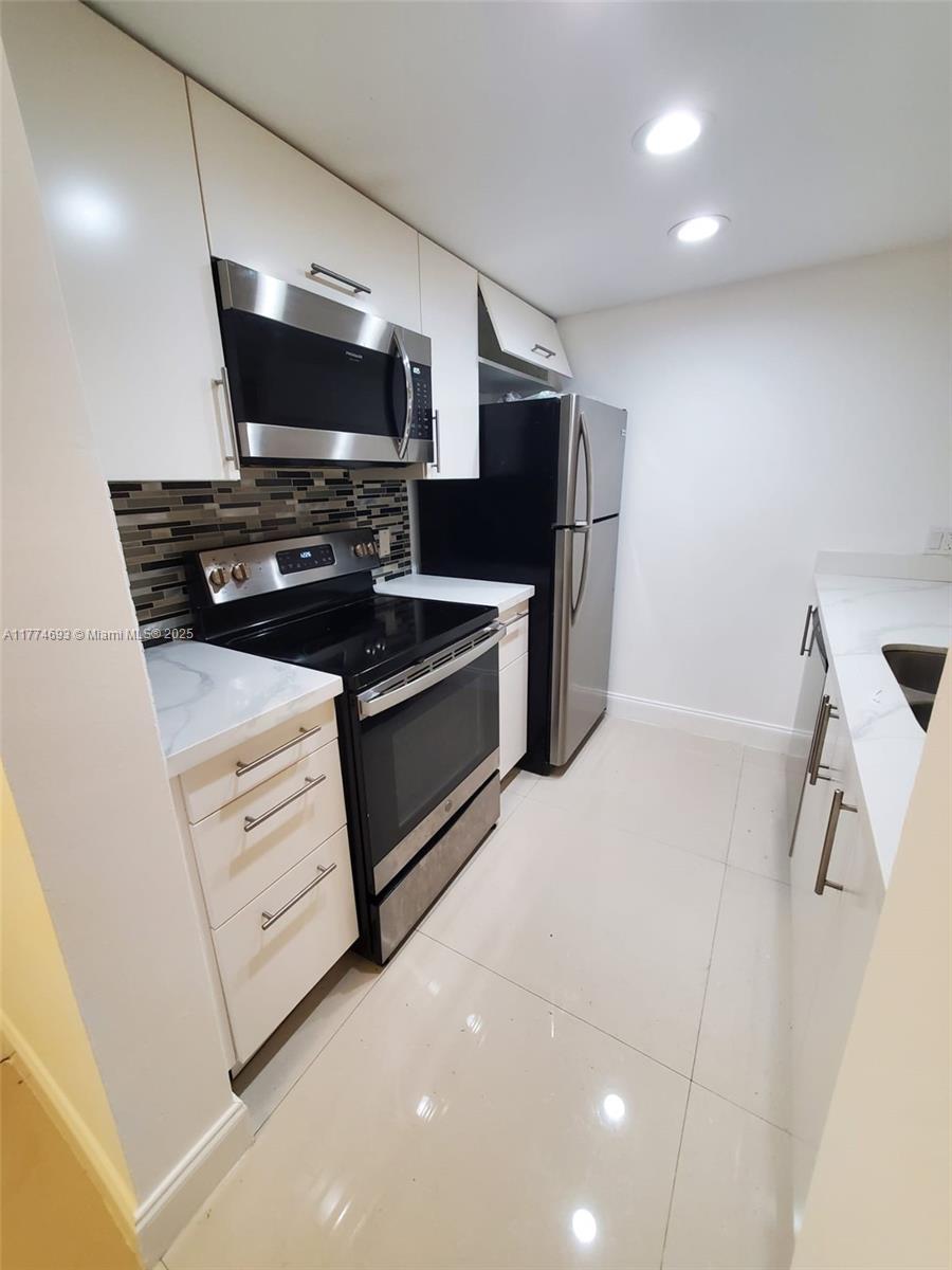 Large and spacious unit at Las Vistas at Doral! Kitchen and baths tastefully remodeled, quartz countertop, stainless steel appliances, modern cabinetry. Large social area plus two large master bedrooms, each with walking closet. Enjoy a very comfortable and private split plan. IMPACT WINDOWS!! Las Vistas is a gated community in the Downtown Doral Area that offers four swimming pools, tennis and racquetball courts, gym and clubhouse with party room and barbecue area. Close to everything!! Steps away from Downtown Doral dining and entertainment venues, access to Doral's A+ schools. Minutes from all major highways!