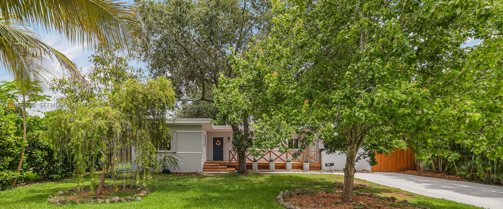 Beautifully updated 3-bedroom, 2-bathroom ranch-style home nestled on an oversized 11,400 SF lot in the heart of Biscayne Park. Thoughtfully expanded with a permitted 2020 addition, this light-filled home seamlessly blends modern living with its original charm. The open floor plan is ideal for everyday living and entertaining, with French doors from the main living area opening to the backyard deck. The spacious primary suite features a walk-in closet, an en-suite bath, and French doors leading to the deck, creating a peaceful, private retreat. 

The updated kitchen features premium stainless steel appliances, including a gas range, and abundant storage. Original Dade County pine and oak flooring adds warmth, character, and timeless appeal throughout. A spacious laundry room with a walk-in pantry offers a private exterior entrance and an adjoining flex space.

A separate plumbed storage room provides flexibility and could easily be converted back into a half bath or incorporated into an expanded bathroom.

The backyard offers a tranquil setting with mature fruit trees, a majestic protected live oak, and an expansive deck that extends the home's indoor-outdoor living. The home features a flat roof installed in 2020.

Ideally located near Miami Country Day School and a variety of highly regarded public, private, and Montessori schools, as well as parks, shopping, dining, and major highways. 

Welcome home. Your Biscayne Park lifestyle begins here.