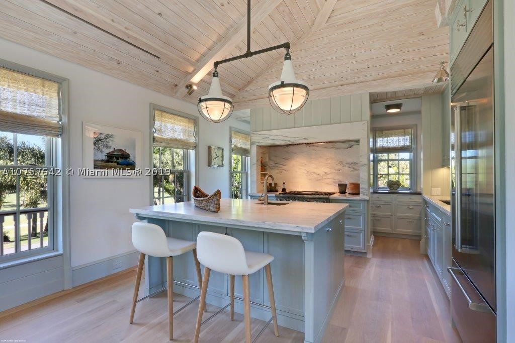 This magnificent 2-story custom home was recently built with the highest quality materials by skilled craftsman to create a marvelously comfortable environment. Enter through caved cypress doors to a breezeway of antiqued tumbled limestone leading to the family areas which include 2 bedrooms, 2 baths and a family room on one side, with a private 1-bedrom, 1 bath guest suite on the other side. Take the elevator up to the main living area, complete with a great room and state-of-the-art kitchen. Master suite complete with his and hers walk-in closet. Take in the panoramic views of the golf course and outdoor entertainment spaces where there is a 36'x17' custom pool, fountain and an expansive pool deck of select white coral. Home comes tastefully furnished with high end electronics.