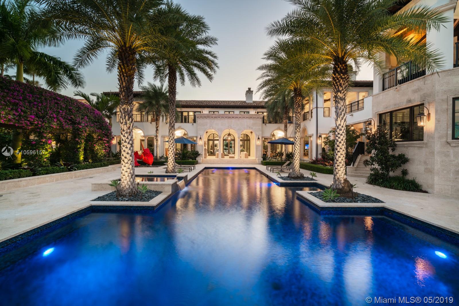 Elegant estate in exclusive, gated Tahiti Beach.  Double height ceilings in living room to showcase prized art work, dining room for 12+.  Den/Library with built in wood shelves.  Chef's kitchen with eat-in countertops, breakfast nook, gas ovens/6 burners, double refrigerator/freezer, full butler's pantry.  Movie screening room with built-in bar & beverage center.  A 2,500 bottle glass wine cellar with 3 temp. controlled zones, large family room features a saltwater fish tank and backlit onyx full bar.  Poker/card room with direct access to incredible covered patio that leads to pool, boat dock, home gym/sauna, health bar.