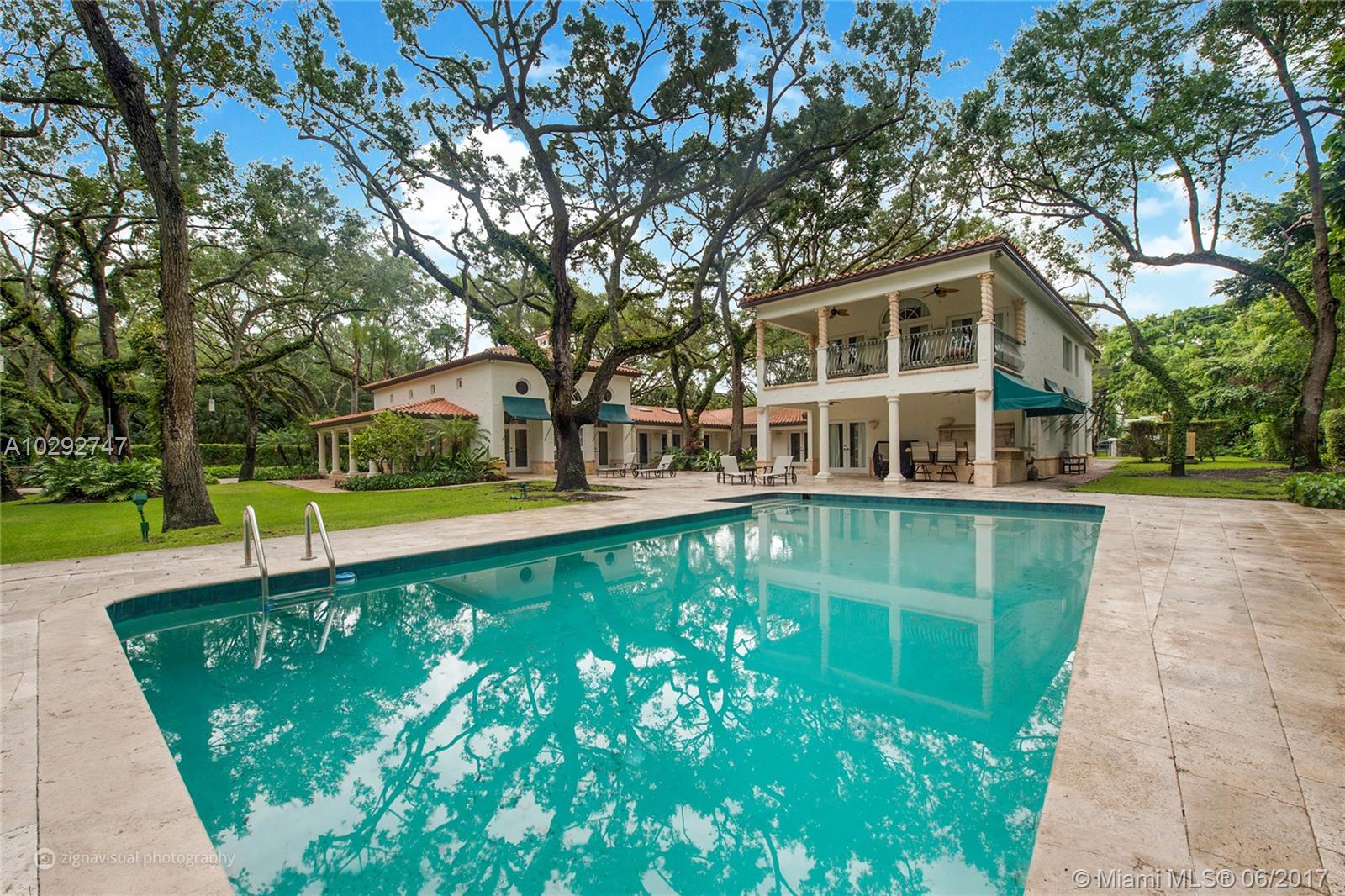 Set on a sprawling 1.5 acre corner lot overlooking a peaceful lake this elegant state enjoys beautiful surroundings in the most desirable gated Snapper Creek. There are generously sized interiors with open plan reception rooms and outdoor spaces for grand entertainment. The property consists of 6 bed/5.2 baths, gourmet kitchen, dining room with fireplace, a grand Master Suite, walk-in closets, marble and wood floors, open terraces and patios adorned with stunning 100 year old trees.