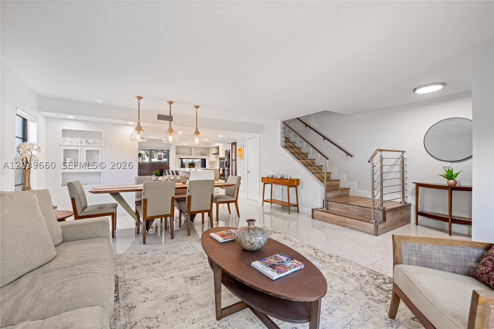 FANTASTIC LAYOUT, EASY LIVING! Rarely available updated 3-bedroom corner townhome in Leeward Point Condo, an intimate waterfront community of just 41 residences. Enjoy the privacy of no neighbors above or below, plus the feel of a single-family home without the maintenance. Light-filled and spacious, this spacious 1,710 SF residence features two living areas, a dining space, open island kitchen, guest powder room, and a private rear patio perfect for entertaining, grilling, or relaxing. Upstairs, you'll find three bedrooms and two full baths, including a generous primary suite with walk-in closet and its own private patio. Recent updates include impact windows and doors, porcelain tile floors, modern kitchen and baths, and a new roof. Full-size in-unit washer and dryer. Two assigned tandem parking spaces are located directly at your front door, plus abundant guest parking. Exceptional amenities not found in other nearby communities include heated pool and sun deck, private tennis courts, fitness center, clubhouse, party room, steam rooms, and bike storage. Stroll the community's private waterfront walkway along Maule Lake and enjoy the boating lifestyle all around you. Tucked away on a quiet tree-lined cul-de-sac in Western Eastern Shores, just minutes from Oleta River State Park, Sunny Isles Beach, Aventura, dining, shopping, and I-95. Great value in a hidden waterfront enclave.
