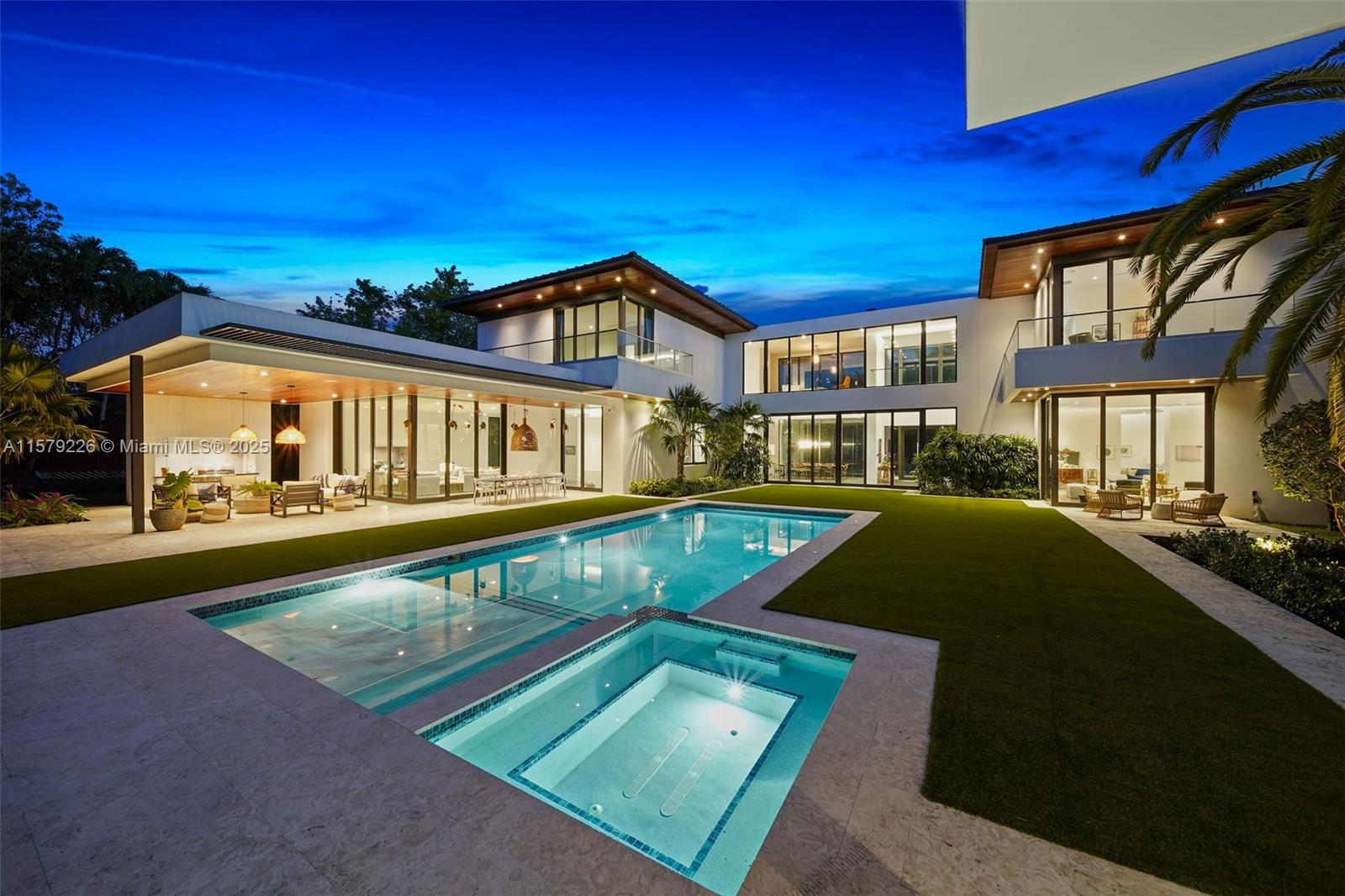 Indulge in the architectural brilliance of this Giorgio Balli-designed masterpiece! A graceful contemporary villa beckons with a grand entrance, complemented by a cascading waterfall. Double-height foyer unveils vistas of the captivating pool and patio. The floor plan maximizes natural light throughout. Seamlessly connecting open yet inviting spaces, the family room and bedrooms boast striking glass corners. Softening accents like tongue-and-groove eaves enhance the ambiance.  Offering versatile living options, including a guest house with a cabana bath and a library. Relish outdoor dining and relaxation on the expansive terrace, equipped with a summer kitchen. The kitchen features Mia Cucina cabinets, Wolf, Miele and Sub-Zero appliances. Home offers an elevator and full-house generator.