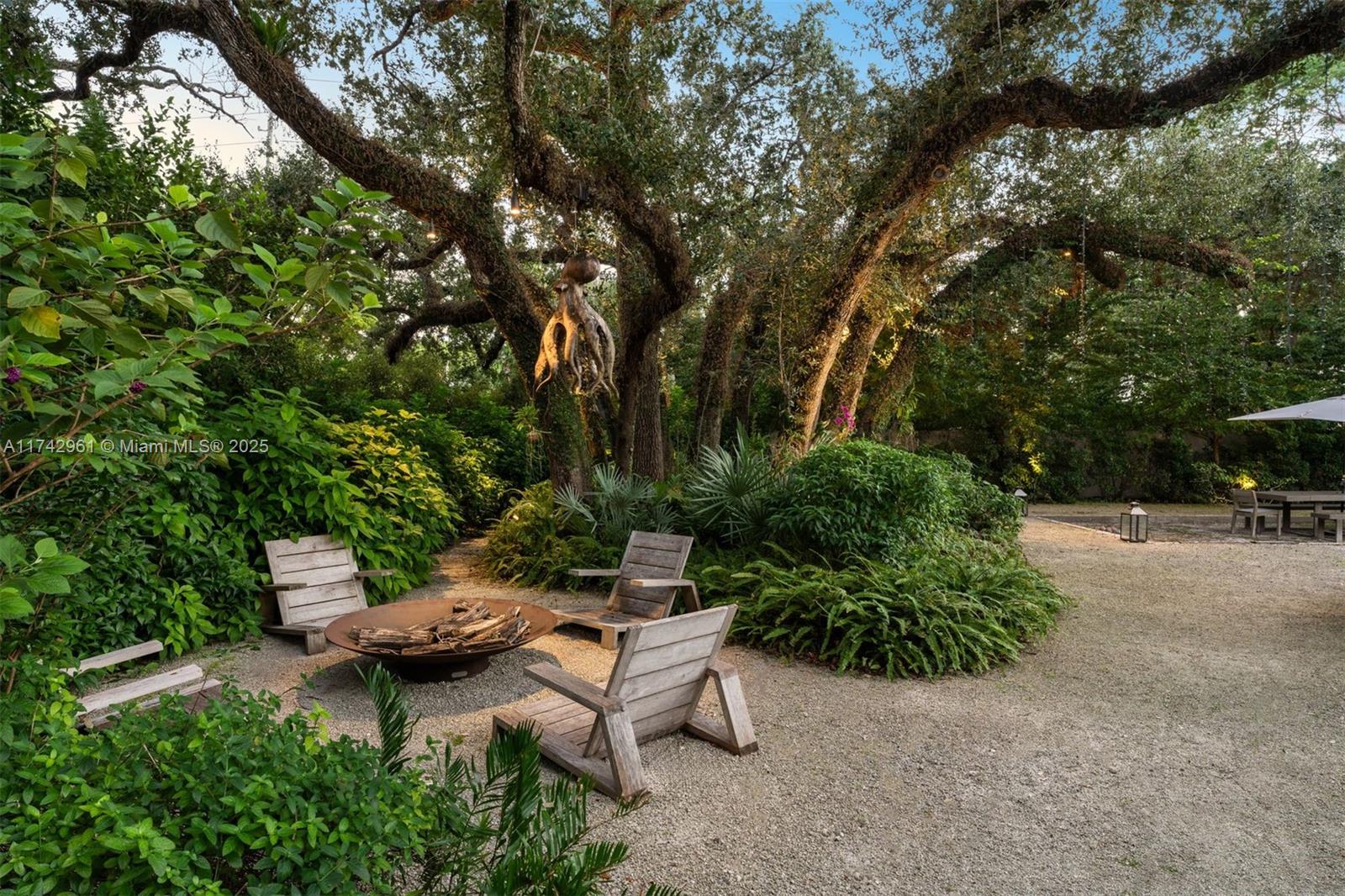 Experience unmatched luxury in this modern 6-bedroom, 7.5-bathroom estate, designed by Max Strang and featured in Architectural Digest, with 9,618 sq ft of living space on a sprawling 1.45-acre lot, reminiscent of the Hanging Gardens of Babylon. Built in 2021, this two-story home offers seamless indoor-outdoor living with retractable floor-to-ceiling windows, high-end finishes, a gourmet kitchen, dual family rooms, and a principal suite with spa-inspired amenities. The lush grounds feature a lap pool, jacuzzi, bocce court, tennis court, fire pit, and expansive terraces with a summer kitchen and BBQ Pit Boys Argentinian brasero grill. Smart home technology, a Sonos music system, and a climate-controlled three-car garage complete this exceptional property.