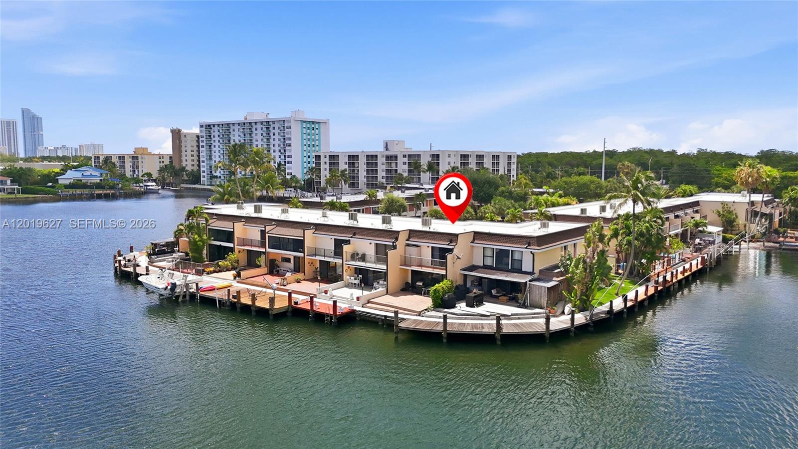 Fantastic wide water views of Maule Lake from this 2 bedroom 2 and 1/2 bath townhouse, in desirable Leeward development. Features new washer and dryer, updated kitchen and appliances. Plenty of closets and built-ins. Laminated and tile floors. Accordion glass impact in the living room facing the deck - great to enjoy the Miami lifestyle. Included space for a dock with saltwater access and, no fixed bridge. Steps to the pool area with assigned parking space and lots of guest parking. Close to the beach and walking distance to restaurants, Oleta Park, Shopping, Houses of Worship, and IPIC theatre. Community recently replaced the roofs with barrel tile roofs. This is a great opportunity to own a piece of paradise. Watch the sunrise from the balcony in your bedroom. This is a Boaters DREAM HOUSE! Don't miss out, this one won't last long!!