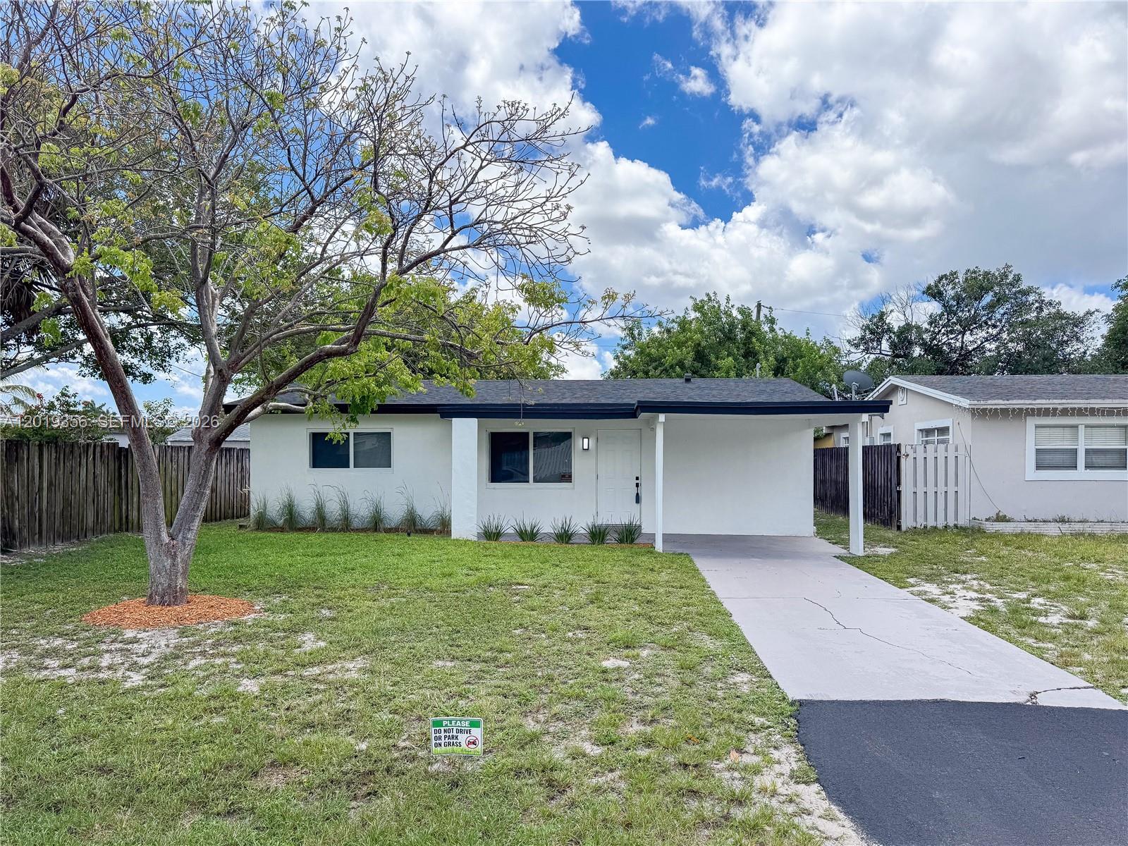 Located in a desirable single-family residential neighborhood, this beautifully updated 3-bedroom, 2-bath home offers modern upgrades and exceptional curb appeal. Renovations completed with permits include a new roof, impact windows and hurricane-approved doors, updated electrical, new flooring throughout, tankless water heater, new interior doors and closets, and fresh interior/exterior paint. The custom kitchen features quartz countertops with matching backsplash, stainless steel appliances, and a full-size side pantry with stackable washer/dryer. Updated bathrooms offer a clean contemporary design. Move-in ready and conveniently located near shopping, schools, major roadways, and local amenities.