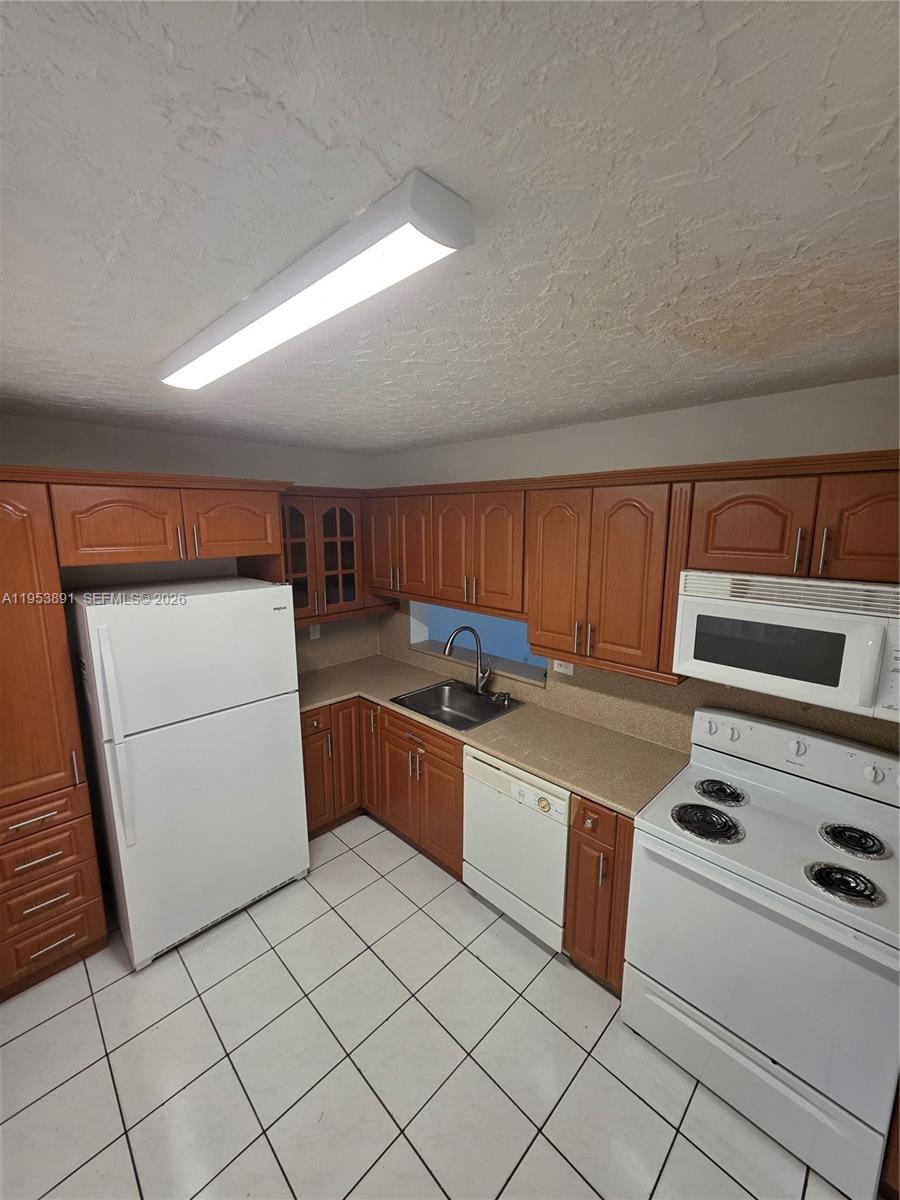 beautiful and well-maintained 2/2 condo in west kendall! all tile throughout for easy maintenance! bright and airy unit with plenty of natural light! enjoy a screened balcony with private storage room! eat-in kitchen plus separate dining area great for everyday living or entertaining! spacious living room with comfortable layout! washer & dryer facilities conveniently located on every floor! community offers excellent amenities including pool, tennis courts, and basketball courts! gated community with guard at gate and 24-hr security patrol! centrally located near shopping, dining, schools, and major highways! move-in ready and easy to show this unit will rent fast!!!!!!