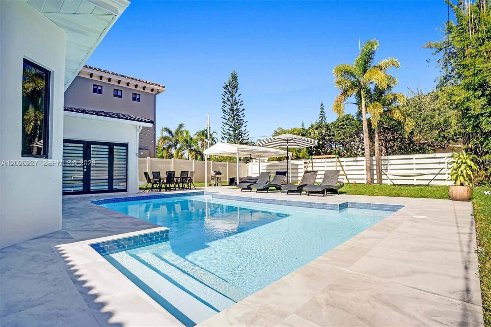 This beautifully updated 4-bedroom, 2-bath POOL home blends comfort, style, and effortless indoor-outdoor living. Elegant marble tile flooring flows throughout the spacious open-concept layout, creating a bright and inviting atmosphere filled with natural light.

At the heart of the home is a stunning renovated kitchen, thoughtfully designed with a large cooktop galley island, generous counter space, and an adjacent dining area ideal for everyday living or entertaining guests. The open living areas seamlessly connect to the outdoors, making this home perfect for hosting and relaxation.

Step outside to your own private backyard oasis, featuring an expansive fenced yard, sparkling in-ground pool, and charming outdoor dining space—perfect for weekend gatherings or enjoying the Florida lifestyle year-round.

Offering spacious bedrooms, ample closet space, and tasteful updates throughout, this move-in-ready gem delivers both comfort and functionality. Ideally located just minutes from the beach and vibrant downtown, enjoy the best of coastal living with shopping, dining, and entertainment all within easy reach.
