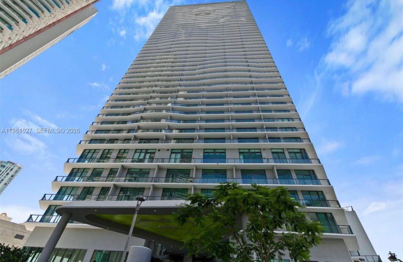 Stunning High-Floor Apartment in the Heart of Miami

Discover the opportunity to own a beautiful apartment on the 18th floor of a prestigious 48-story building in Miami. This residence offers comfort, style, and convenience, with breathtaking panoramic city and water views that elevate everyday living.

The apartment features two private balconies with spectacular views of the Miami skyline and the bay—perfect for morning coffee or relaxing at sunset.

Inside, there are 2 spacious bedrooms, including a primary suite with a walk-in closet, and 2 full bathrooms. The open-concept layout connects the living and dining areas, creating a bright space ideal for daily living and entertaining. Floor-to-ceiling sliding glass doors bring in abundant natural light and provide direct access to the balconies.

The kitchen is designed with solid wood cabinets, stone countertops, and all appliances included, combining functionality with modern appeal.

An enclosed den with a door offers a versatile private space, ideal for a home office or guest room.

The unit includes 1 assigned parking space and elevator access. Residents enjoy amenities such as a resort-style pool, gym, playground, game room, and clubhouse. Conveniently located near I-195, with easy access to shopping, dining, entertainment, and excellent schools, this move-in-ready home is a must-see.