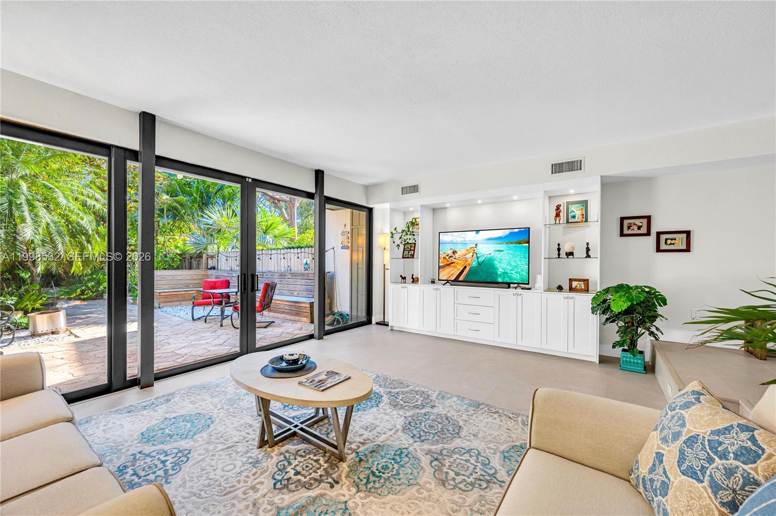 Welcome to this beautifully renovated, private townhouse in the highly sought-after gated community of Lake Ridge in Miami. Nestled within a lush, natural setting, this exceptional residence offers the perfect blend of tranquility and convenience. The home features a stunning white kitchen with new appliances, complimented by elegant porcelain floors throughout. A spacious living room opens seamlessly to a private, tree-lined patio with lush landscaping—ideal for indoor-outdoor living and entertaining. The ground floor also includes a bedroom and full bath, perfect for guests or flexible use. Upstairs, the expansive primary suite impresses with vaulted ceilings, a large walk-in closet, and a beautifully appointed bathroom featuring a generous walk-in shower. An additional upstairs bedroom offers its own ensuite bath, ample closet space, and a spacious layout. Impact windows and doors, new roof, new siding, new appliances - everything is done !  Lake Ridge is known for its serene, nature-filled environment, complete with a clean, usable lake, kayaking, tennis, and a waterfront pool. Enjoy peaceful strolls along the water while being just minutes from Coral Gables, the University of Miami, and a wide array of shopping, dining, and entertainment. A rare opportunity to enjoy refined living in one of Miami’s most desirable communities.