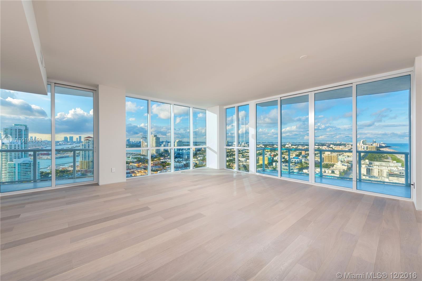 Inspired by the surrounding sand and ocean, designed with natural materials including oak wood floors, an integrated oak kitchen, travertine & oak bathrooms with corian vanities allowing an uninterrupted Atlantic Ocean, Biscayne Bay and Downtown Miami view to be the focal point. No expense was spared including floating walls and eight foot frameless Italian doors with dramatic wall washed mood lighting and the highest quality craftsmanship creating a truly sophisticated ambiance.