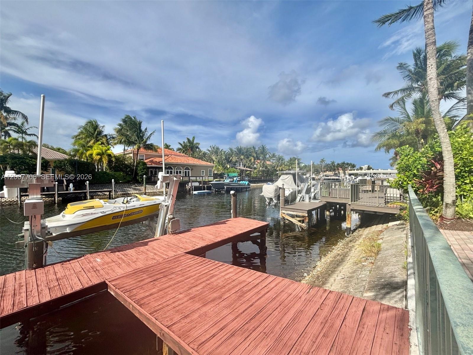 Welcome to a truly one-of-a-kind coastal retreat—this exceptional WATERFRONT 2 story estate, once owned by the legendary Joe DiMaggio, blends timeless prestige with modern luxury. Nestled in the exclusive GATED community of HARBOR ISLANDS (east Hollywood), this 5/4 POOL home offers an unparalleled lifestyle with access to resort-style amenities including tennis courts, a resort-style community pool, state-of-the-art fitness center, private marina, 24 hour security, pickleball, etc. The main residence features 4 spacious bedrooms & 3 full bathrooms. High ceilings in the entire house. Adding to the appeal is a separate GUEST HOUSE with its own private bedroom & bathroom (5th bedroom/4th bathroom).The property also boasts a 3-car paved driveway and a rare PRIVATE 40ft BOAT DOCK with a 20,000 BOAT LIFT, making it a dream for boating enthusiasts! Maintenance fees include cable, WiFi, landscaping, pool cleaning, alarm system, 24 hr manned security, & all amenities. Centrally located with less than 2 miles to the BEACH, 15 min to Ft Lauderdale airport and close to all grocery stores/shops. A rare opportunity to own a WATERFRONT home in this exclusive community at an exceptional value. The listing agent is the owner of the house.