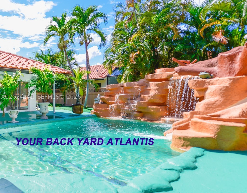 Exciting Resort style “Back Yard Water Park” with a thrilling kids water slide, and an amazing rock mountain cascading water wall and another huge waterfall that sounds like the ocean waves and a quite river stream, with huge palm trees covering the back yard. This renovated house has giant windows in every room giving massive picturesque lighting into every room. With a tennis court / pickle ball court, and a basketball court in addition to the back yard water park, this house is unbeatable. It’s only two blocks from the Town Center Mall, Publix, Walgreens and five of the top schools. This is your dream 3,000 sq ft "Open Concept Home Design” house with two huge Great Rooms with soaring ceilings and separate living/dining/family rooms. This fully remodeled open concept kitchen has new quartz countertops, and all new stainless steel appliances, stove, fridge, washer and dryer, including a huge food storage freezer hidden in the wall. The new bathrooms are absolutely beautiful, with a Jacuzzi jet tub in the master bedroom special white tile, new bathroom fixtures, and an great bright ceiling skylight.  All the appliances, water heater, pool equipment, and both air conditioning systems are all virtually brand new, along with completely renovated landscaped grounds and a maintenance free back yard with beautiful grass carpeting. All doors and windows will be Brand New Category 5 Hurricane Impact  in this home of your dreams that includes super low HOA fees.