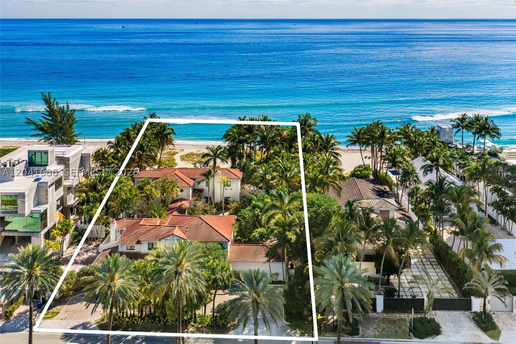 Exceptional oceanfront Mediterranean estate with 150 feet of direct Atlantic Ocean frontage in the exclusive community of Golden Beach. Originally built in 1936 and thoughtfully updated, this private compound features a main residence with a dedicated primary wing, guest house, staff accommodations, multiple living and entertaining spaces, impact glass windows, and marble floors throughout. An elegant interior loggia connects the various structures, creating seamless indoor-outdoor living. The expansive grounds include an oceanfront pool, beach cabana, lush lawns, and secure perimeter walls offering unparalleled privacy. A rare opportunity to own a legacy beachfront estate in one of South Florida’s most coveted oceanfront communities.