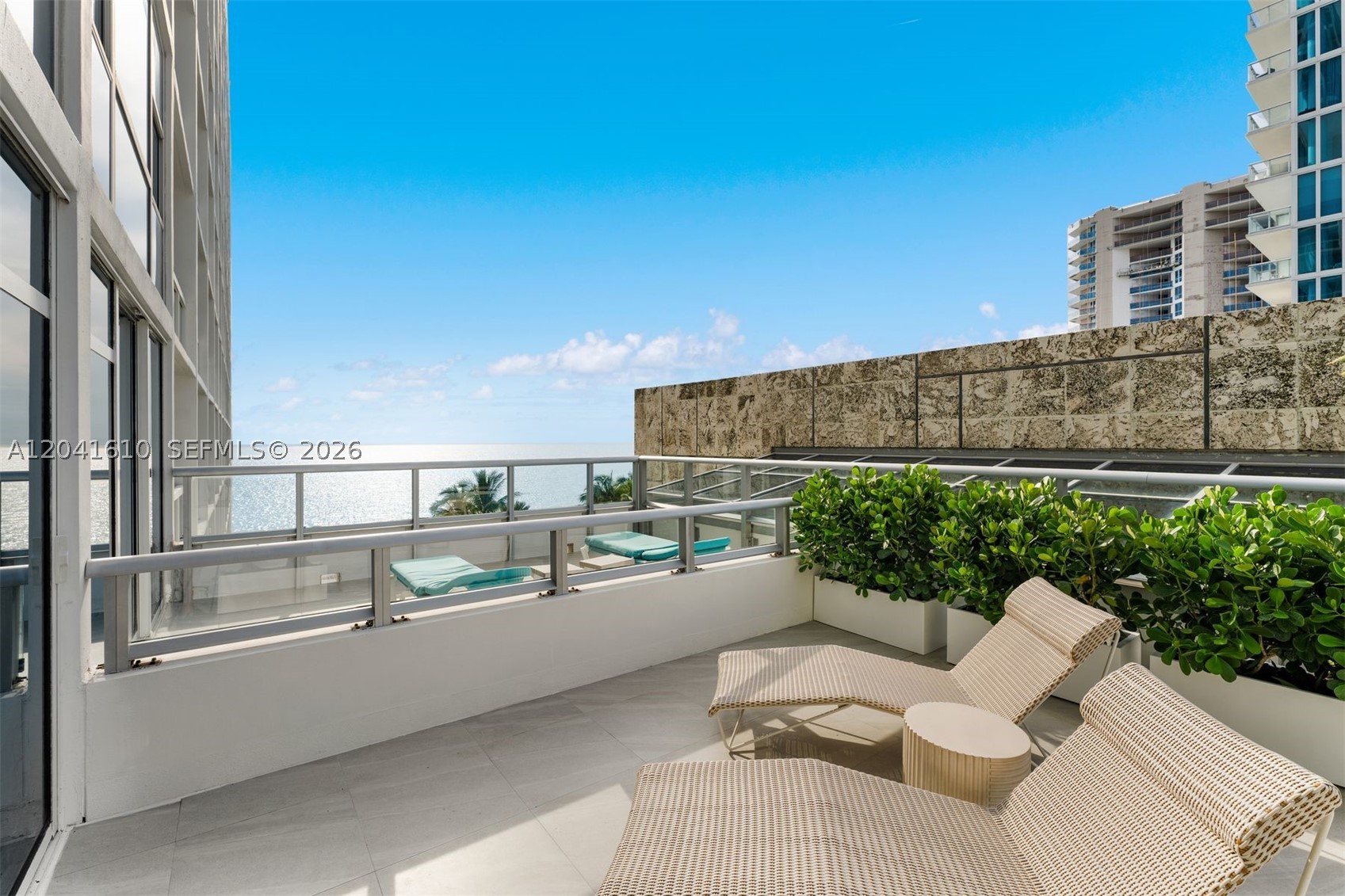 Rare turnkey opportunity at the prestigious Carillon Miami Wellness Resort! This extra-spacious 1BR/1BA ocean-view condo-hotel suite seamlessly blends 5-star resort luxury with the comforts of home. Featuring a bright, open floor plan meticulously styled with high-end coastal modern decor, the unit is configured for maximum rental yield with two queen beds and a sleeper sofa. The layout boasts a fully equipped chef's kitchen, an in-unit washer/dryer, and a spa-like bathroom with a deep soaking tub and separate rain shower. Step out onto the massive, fully furnished private terrace to enjoy ocean breezes and stunning backdrops.

Enjoy unparalleled resort amenities: direct beach access with private beach service (chairs, umbrellas, towels), oceanfront pools, hot tubs, complimentary valet parking, and gourmet on-site dining—including the Michelin-starred Tambourine Room. Residents can opt into the world-renowned 70,000 SF wellness spa and state-of-the-art fitness center. Located in serene North Beach, just minutes from South Beach and Bal Harbour shopping. This asset offers incredible short-term rental flexibility with an immaculate, established guest history and future bookings already in place. Sold fully furnished and ready for immediate cash flow from Day One!
