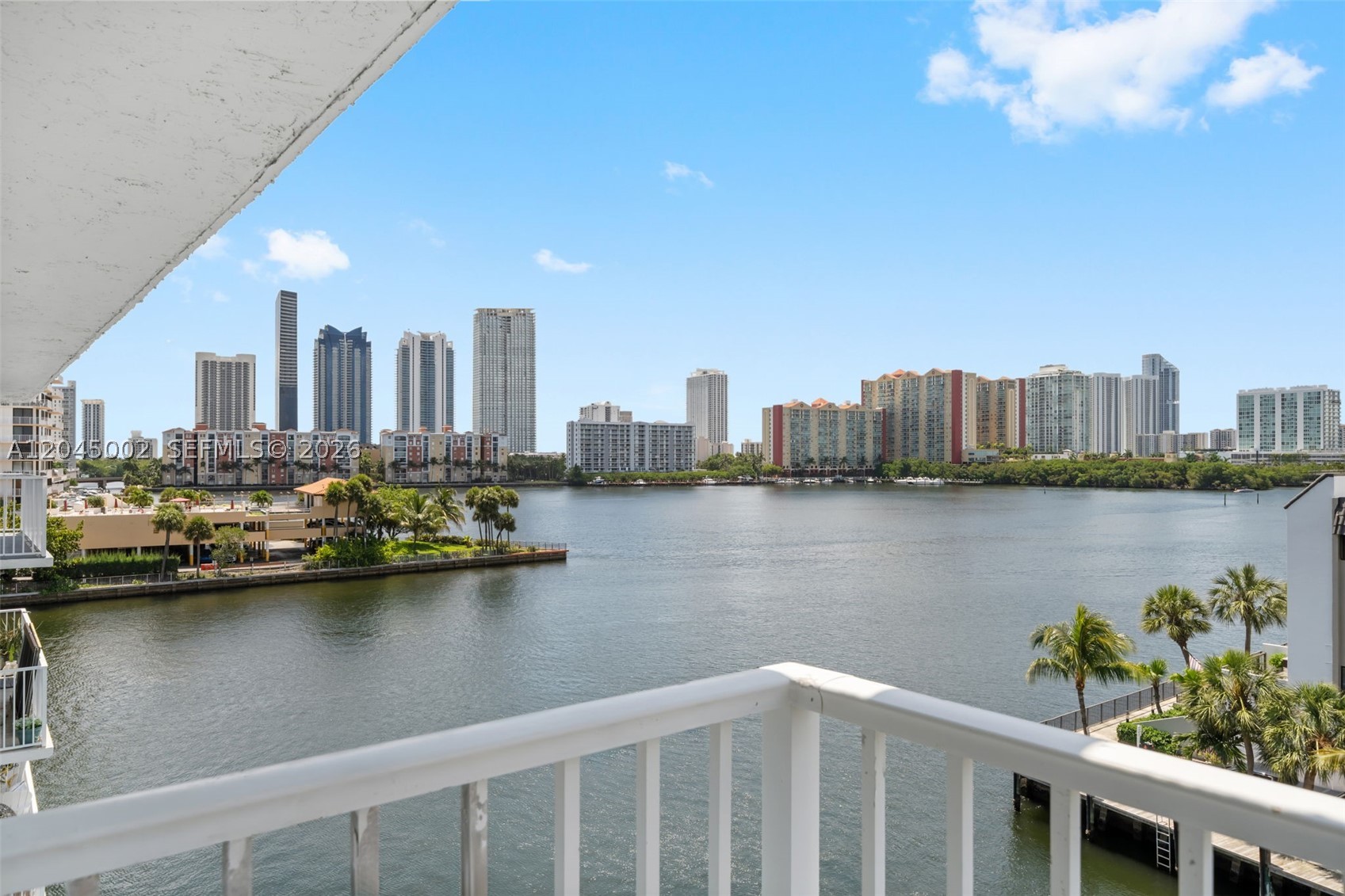 Welcome to Condo Azure. Wake up to breathtaking panoramic bay views and experience waterfront living at its finest in sought-after Eden Point South. This exceptional corner residence captures spectacular sunrises over the bay and vibrant Miami skyline sunsets from an expansive wraparound balcony, creating the perfect setting for seamless indoor-outdoor living and entertaining. Inside, the bright 2-bedroom, 2-bath residence features impact windows and doors, a spacious living and dining area, a kitchen with breakfast nook, generous storage, a large walk-in closet, and central A/C. Move-in ready and thoughtfully designed to maximize natural light and water views from nearly every room. Residents enjoy a waterfront pool, community laundry, and an unbeatable location just minutes from Aventura Mall, beaches, restaurants, shopping, and parks. Whether you're looking for a full-time residence, seasonal retreat, or waterfront investment, Condo Azure offers the South Florida lifestyle defined by exceptional views, tranquility, and convenience.
