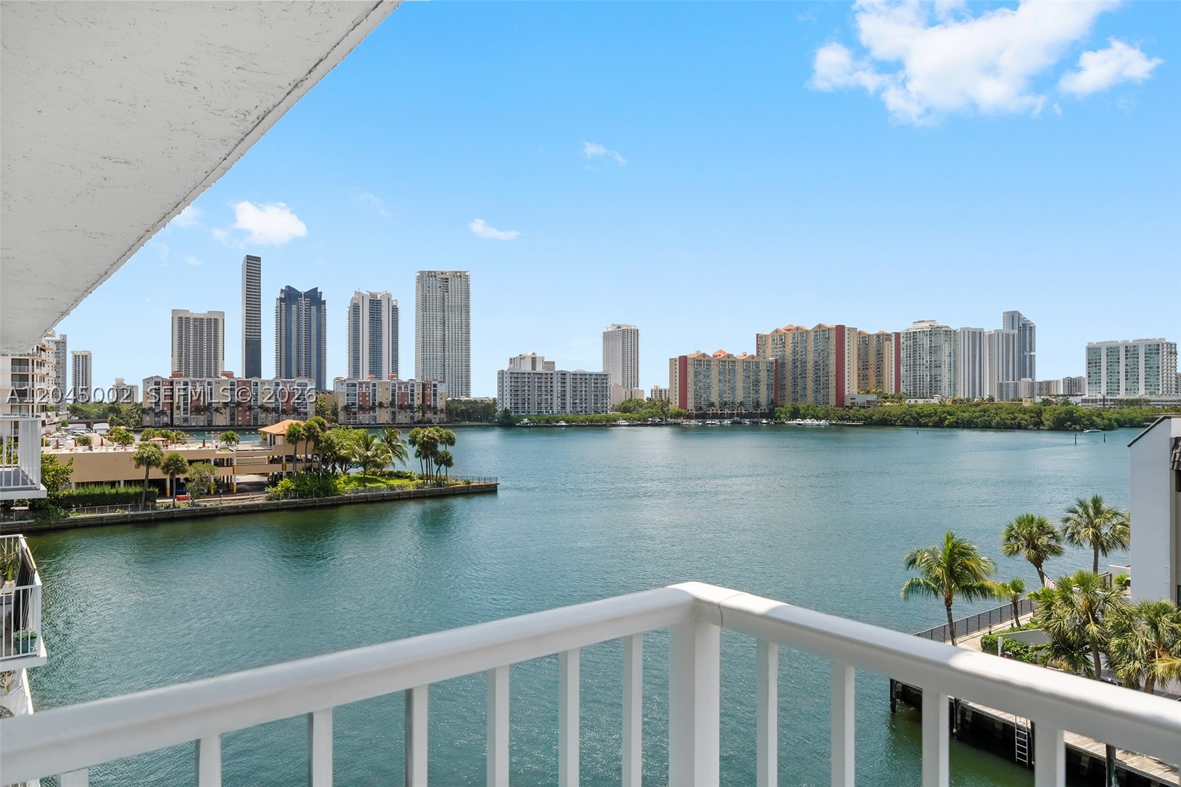 Welcome to Condo Azure. Wake up to breathtaking panoramic bay views and experience waterfront living at its finest in sought-after Eden Point South. This exceptional corner residence captures spectacular sunrises over the bay and vibrant Miami skyline sunsets from an expansive wraparound balcony, creating the perfect setting for seamless indoor-outdoor living and entertaining. Inside, the bright 2-bedroom, 2-bath residence features impact windows and doors, a spacious living and dining area, a kitchen with breakfast nook, generous storage, a large walk-in closet, and central A/C. Move-in ready and thoughtfully designed to maximize natural light and water views from nearly every room. Residents enjoy a waterfront pool, community laundry, and an unbeatable location just minutes from Aventura Mall, beaches, restaurants, shopping, and parks. Whether you're looking for a full-time residence, seasonal retreat, or waterfront investment, Condo Azure offers the South Florida lifestyle defined by exceptional views, tranquility, and convenience.