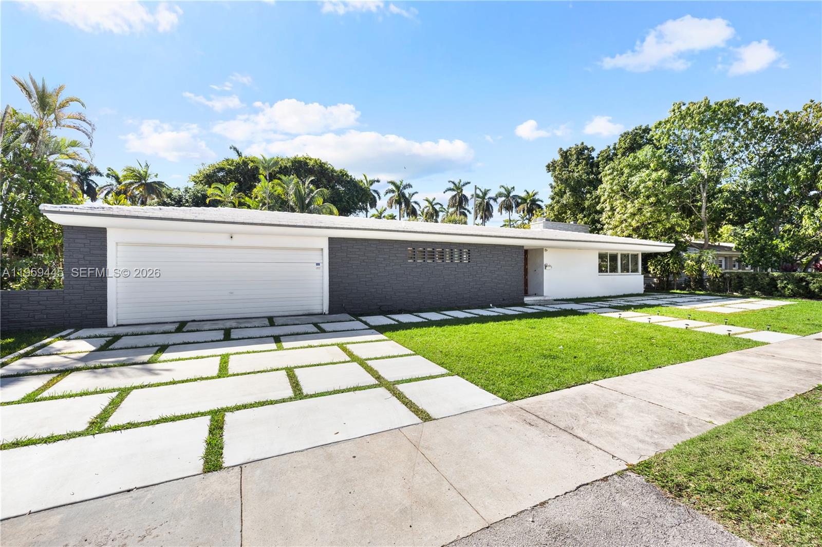 Designed with entertaining in mind, this beautifully upgraded home offers the ultimate South Florida lifestyle. 

Located at 1040 NE 86th St, this extensively renovated residence offers 2,988 SF of thoughtfully designed living space, featuring 2 bedrooms and 3 bathrooms. Blending timeless design with modern upgrades, the home showcases terrazzo and white tile flooring throughout.

The spacious and functional layout is ideal for both comfortable daily living and hosting guests. A dedicated entertainment room serves as a standout feature, complete with a fully customized wet bar, creating the perfect space for gatherings and celebrations. The spacious primary suite is thoughtfully designed with two custom walk-in closets, a fingerprint-access automatic door lock for added security, and sliding glass doors offering direct access to the backyard retreat. 

Designed to embrace South Florida’s indoor-outdoor lifestyle, the outdoor space features a saltwater pool, covered lounge areas, new patio stonework, astroturf landscaping, and updated fencing. Integrated surround sound speakers extend throughout both the interior and exterior of the home, creating a seamless entertainment experience.

Additional highlights include a two-car covered garage, a laundry room conveniently located just off the kitchen, a full security camera system, and high-impact windows for enhanced safety and peace of mind.