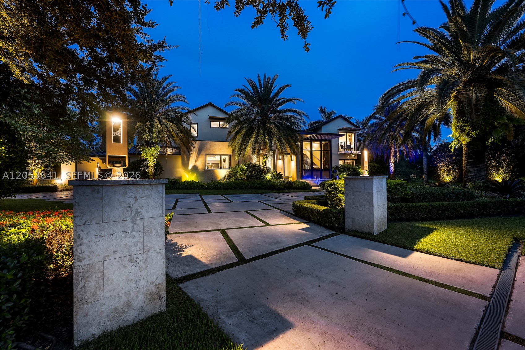 Experience exceptional lakefront living in Windmill Lake Estates, where contemporary architecture, privacy, and sophisticated design converge on an expansive 44,492-square-foot cul-de-sac lot. Designed and custom-built by award-winning architect Nelson de León, AIA of Locus Architecture, this impressive residence offers 6 bedrooms, 5 bathrooms, and 5,178 square feet under air, thoughtfully created for everyday living and entertaining. Soaring ceilings, 2-story impact windows and doors throughout the home, custom closets, and a premium sound system enhance the modern interiors. Extensively upgraded throughout with four AC units, whole-house audio/video with voice control, and gigabyte Wi-Fi with repeaters for full-property coverage. The chef's kitchen features quartzite countertops, top-of-the-line Miele appliances, a wine cooler, and an oversized island with seating. The outdoor living spaces are equally impressive with a coral stone terrace, summer kitchen with built-in grill, infinity-edge pool, and spa overlooking tranquil lake views. Dual high-capacity water heaters, a rare gas line connection and on-premises tank, detached three-car garage with covered portico, generous driveway, and abundant guest parking complete this exceptional property. Built in 2014 on a remarkable oversized lot, this custom lakefront residence offers a rare opportunity to enjoy space, privacy, architectural distinction, and the highly sought-after Weston lifestyle.