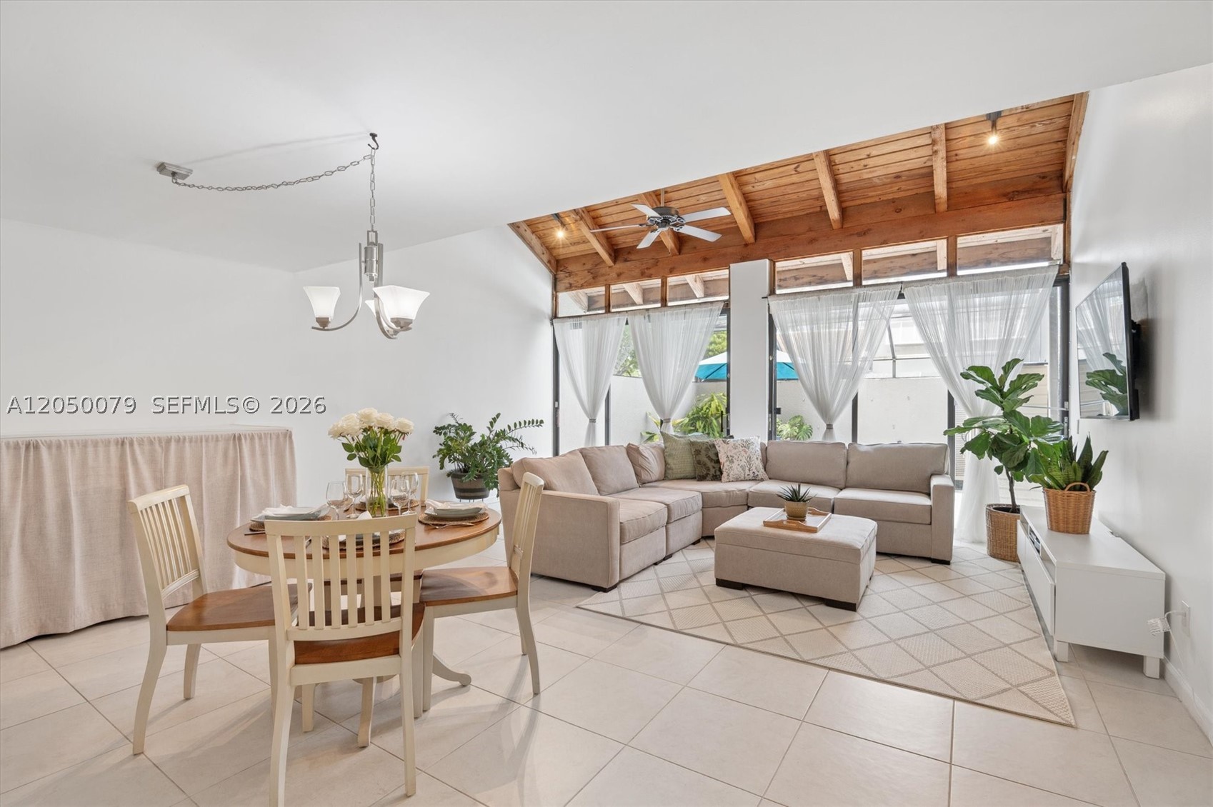 Discover this beautifully maintained corner unit, three-bedroom, two-bath townhome in the heart of Pembroke Pines. The open living area features vaulted ceilings, enhancing the spacious feel.  Enjoy the convenience of a first-floor bedroom with a full bathroom, perfect for guests or a home office. The screened-in patio invites outdoor living, while the second floor hosts two additional bedrooms, including a large master suite with a walk-in closet and a beautifully renovated bath. The kitchen boasts stainless steel appliances, granite counter top with seating that opens to a  spacious 
dining-living combination. Full size washer and dryer. Tile flooring throughout with wood-interlock in master bedroom. 2 parking spaces in front of unit. Roof installed in 2021. With low HOA fees, the community offers a swimming pool, clubhouse, pickleball, handball and basketball courts, all just minutes from shopping, dining, A rated schools, and entertainment options. Experience an outstanding lifestyle in Pembroke Pines!