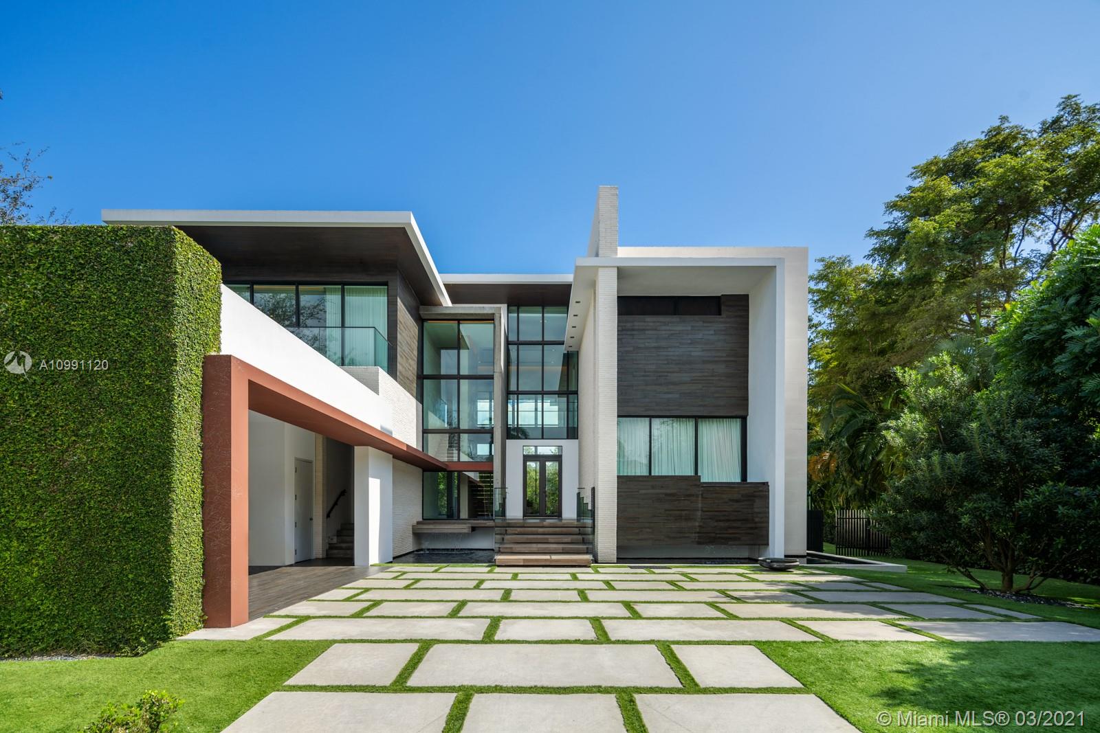 Enjoy the best of Both Worlds in this Miami Beach Modern in Coral Gables’ gated amenity-rich Islands of Cocoplum.Both glamorous & casual,best design & finishes are flawlessly executed.Limestone & Italian wood floors,marbelized walls,Boffi kitchen,Handcraft millwork & built ins,Element lighting,matt-glazed oxidized steel cabinet & room divider pivot doors,hand painted+Moroccan tile accent the soaring ceilings & views of the edgeless pool,deck & lush waterfront through floor to ceiling glass.2/2/1 downstairs includes a staff or guest suite. Dreamy master suite,w Polyform closets,spa bath+terrace.Addtl 2/2 upstairs share 2nd family room.Outdoor areas are big on PRIVACY,w covered terraces,wood & glass-railed decks,summer kitchen,ample green areas,private dock. playroom+media.Elevator/Generator