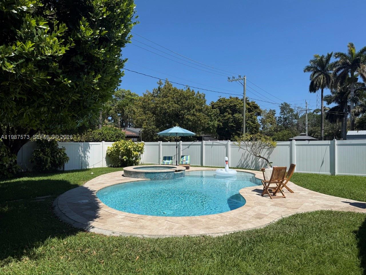 Just minutes from the beach, this bright and beautifully updated pool home in Hollywood offers your own private oasis. Situated on an oversized, lushly landscaped lot, the property features a custom heated saltwater pool with sun shelf and spa, built in 2019—perfect for relaxing or entertaining.

This 2-bedroom, 1-bath home plus a versatile den/office is located in the highly sought-after Hollywood Lakes community, directly across from the Eco Golf Course. Move-in ready, the home showcases an updated kitchen with newer cabinetry, quartz countertops, and stainless steel appliances, including a wall oven, microwave, double-door refrigerator, dishwasher, and gas cooktop.

Interior highlights include an updated bathroom, generous wall-to-wall closets, new interior doors, porcelain tile and travertine flooring, and a separate laundry area for added convenience.

Exterior upgrades include a new barrel tile roof (2023), A/C (2022), and full impact windows and doors. The circular driveway accommodates up to five vehicles, and a screened-in back porch offers the perfect space to enjoy the South Florida lifestyle year-round.

Ideally located just minutes from the beach, Fort Lauderdale-Hollywood International Airport, and Downtown Hollywood, you’ll enjoy easy access to dining, shopping, and entertainment. Whether it’s a day at the beach or a night out on the town, this home truly has it all.  "please see broker remarks"