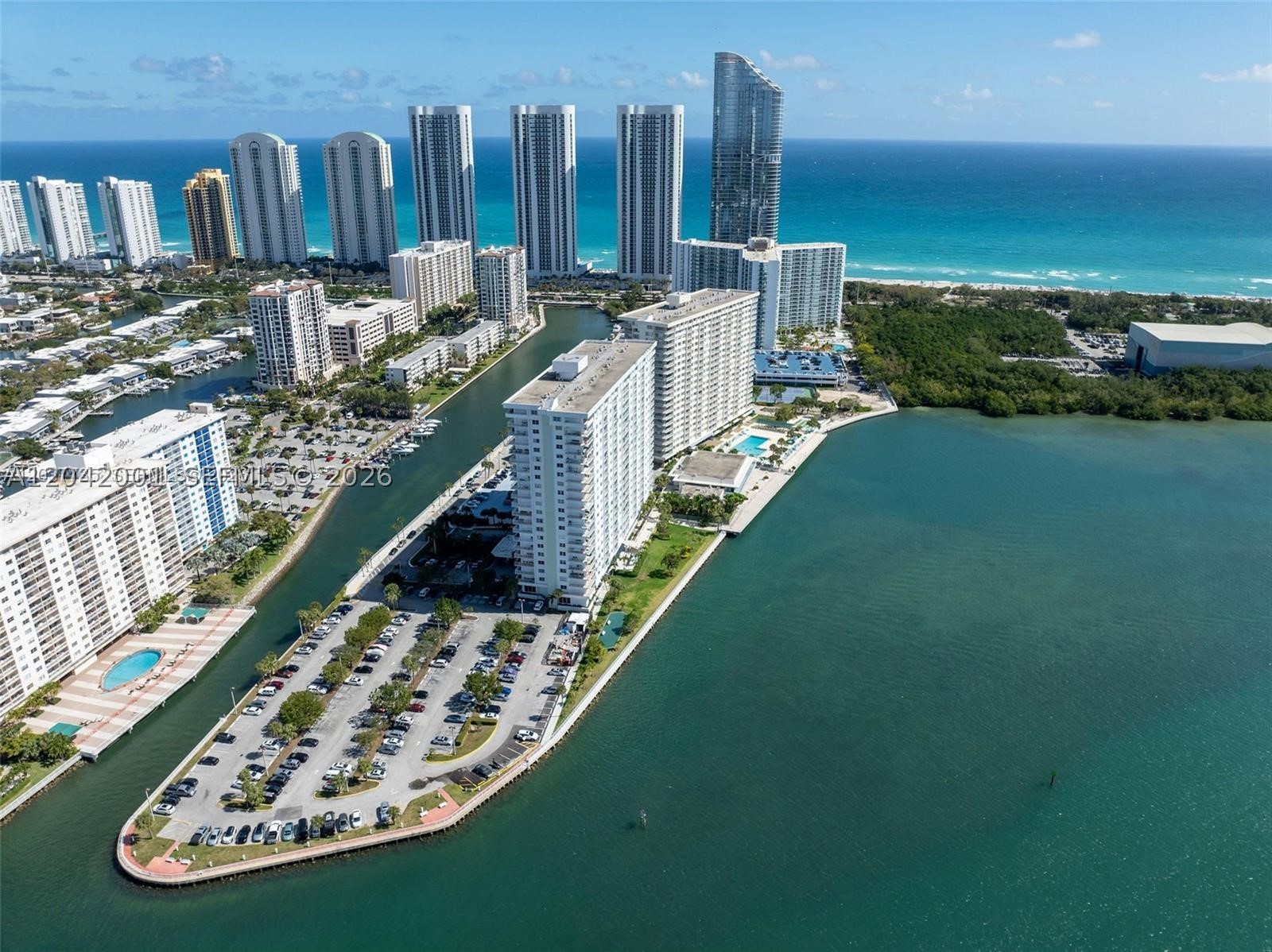 Completely renovated and move-in ready corner residence with an expansive wrap-around balcony and partial Intracoastal views. This bright 2BR/2BA home showcases high-end finishes throughout, including oversized porcelain floors, a brand-new custom kitchen with stainless steel appliances, designer bathrooms, impact windows and doors, and abundant natural light. Every detail has been thoughtfully updated, offering the feel of a brand-new home. Ideally located near the beach, Bal Harbour Shops, restaurants, and parks. A turnkey opportunity ready for immediate enjoyment.