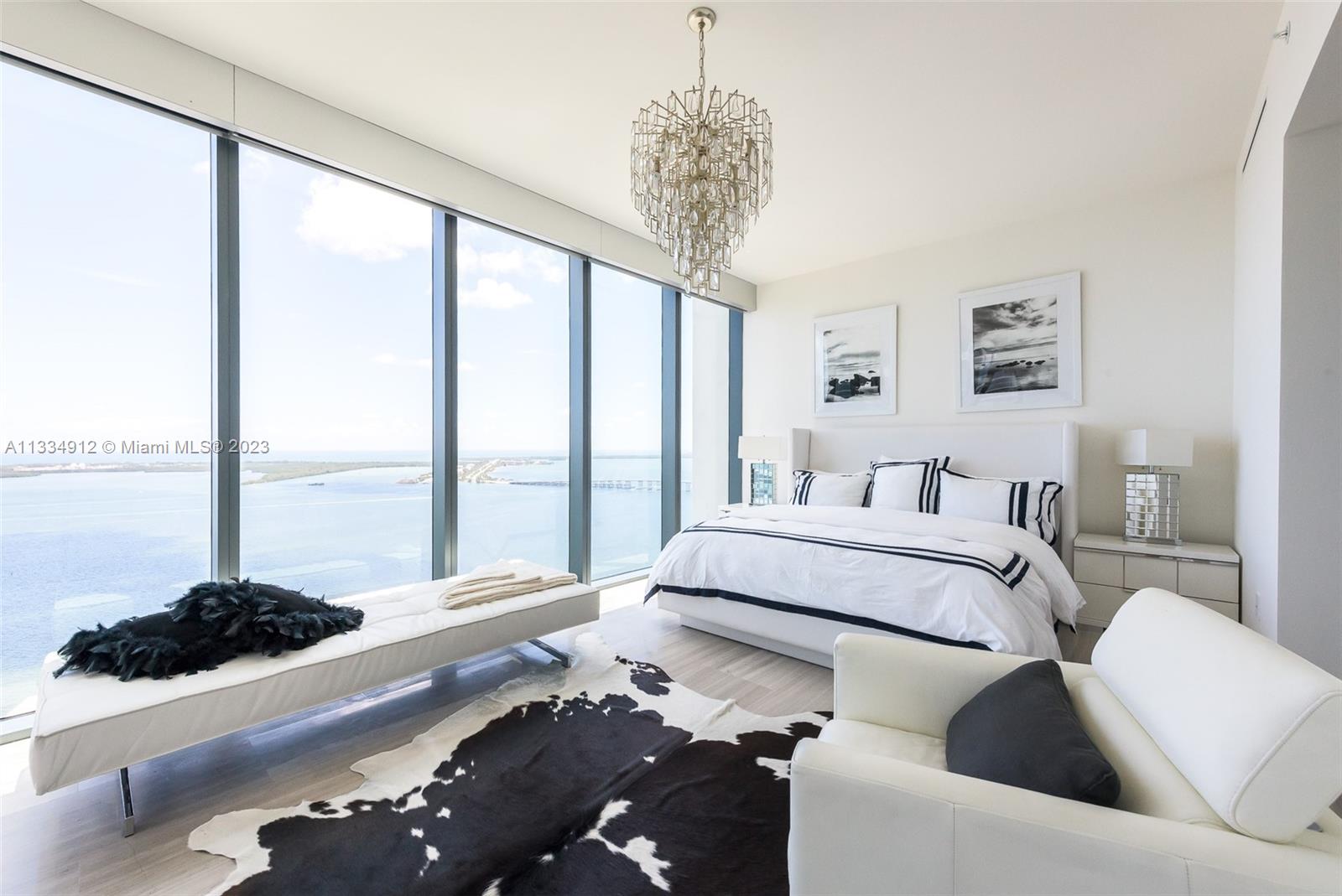 Corner 2 bedroom + den & 3 full baths. One of three units on its floor with this unit being the only one on its side providing extra privacy. Stunning unobstructed water and city views. Two parking spaces. Exquisitely designed with breathtaking panoramic views from every room. Summer kitchen perfect for entertaining on your 8 foot deep terrace and second wrap around balcony from main to second bedroom. Fully functioning pool bar. In-house chauffeur services & on call dog walkers.