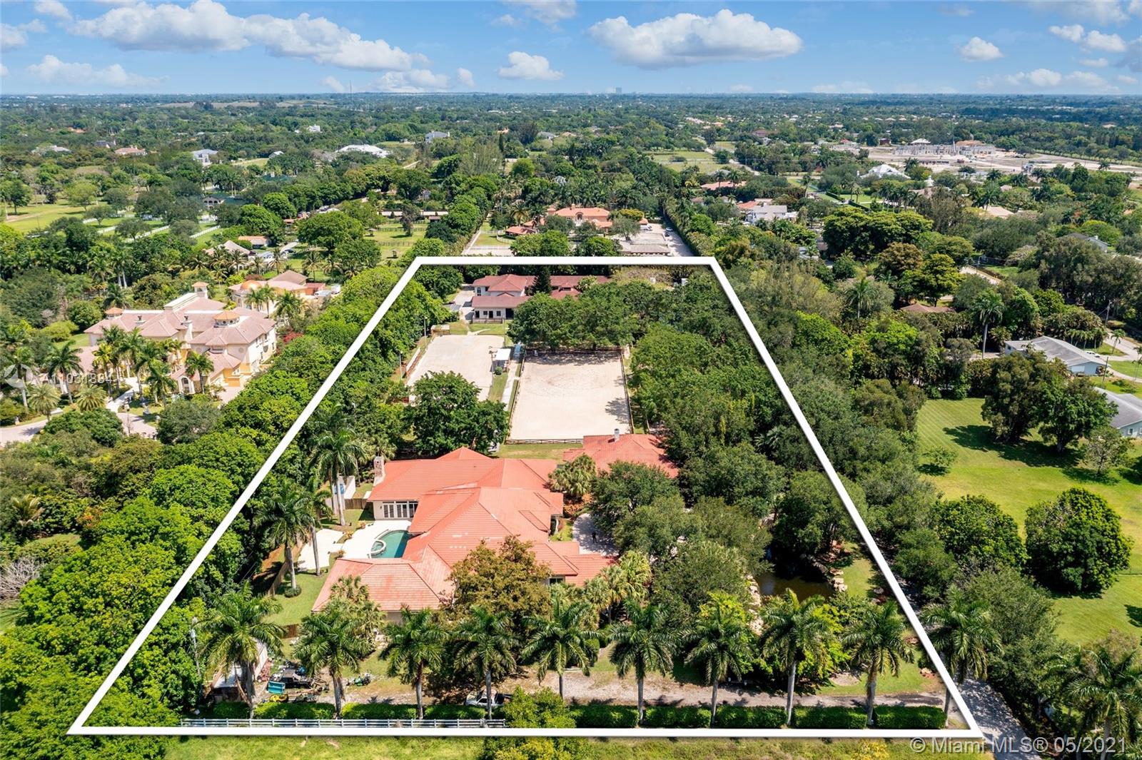 The finest and most elite Equestrian estate and ranch in Southwest Ranches. “Dancing Horse Ranch” offers the highest quality residential lifestyle along with the best in class equestrian horse facilities between Wellington and Miami. This Palatial Equestrian Estate w Guest House sitting on 6 acres with over 13,000SF of living space, offers the finest wood design and workmanship, with incomparable gourmet kitchen finishes, billiard room and bar, unmatched theater room for over 20 people, library, office, wine room, gym, 2 dressage and jumper rings, state of the art barn with 16 stalls, gazebo with summer kitchen, grooms quarters and waterfalls with pond. This property offers the complete package for the avid equestrian lover.