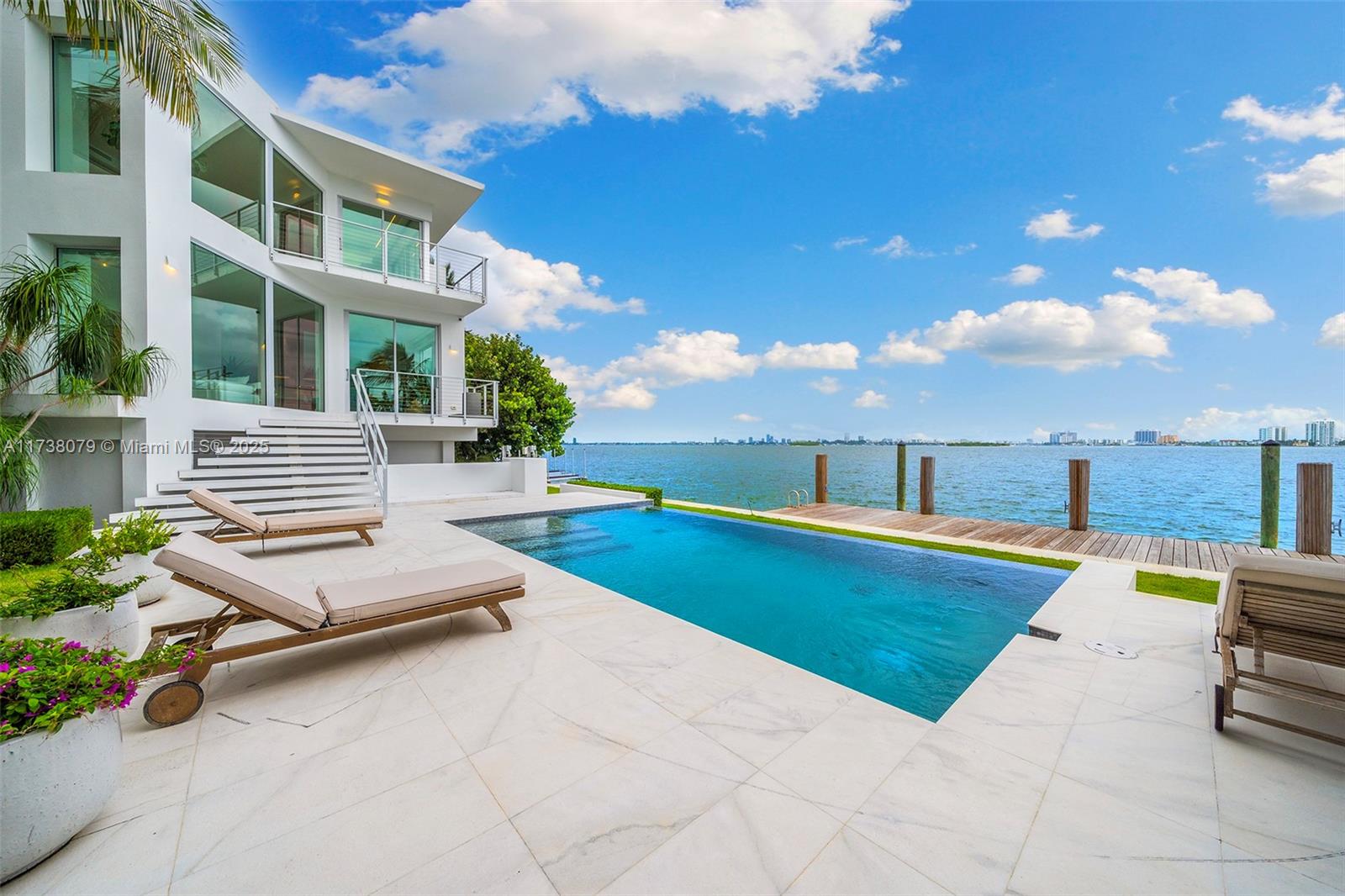 Exquisite Waterfront Villa with Stunning Bay Views
Nestled on an oversized 15,000 SQ FT lot with over 150 feet of open bay frontage, this exceptional villa offers breathtaking panoramic views of Downtown Miami, Miami Beach, and Edgewater. Enjoy both sunrises and sunsets from this prime location. This spectacular 6-bedroom, 7-bathroom residence features a maid’s quarter, private gym, theater, and elevator. The master suite spans over 1,000 SQ FT, complete with a steam room and an expansive 1,000 SQ FT private terrace—a true retreat of luxury.Located in the serene neighborhood of Miami Shores, just a few blocks from Miami Country Day School, this home offers a private dock with space for a 60-foot yacht.