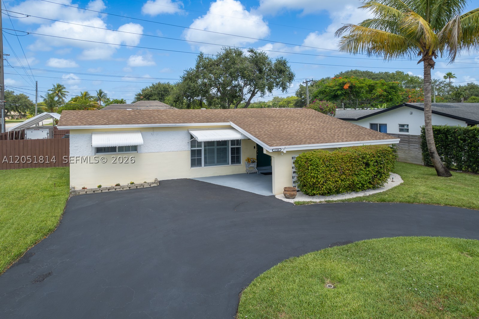 One of the largest corner lots in Hollywood Hills! Beautifully updated and move-in ready, this meticulously maintained 3BR/2BA home sits on an impressive 11,034 SF corner lot and offers exceptional outdoor living, quality upgrades, and an unbeatable location. Natural light fills the spacious living areas, accented by smooth ceilings and beautiful Pergo wood-look flooring. A 500+ SF screened patio overlooks the spacious fenced backyard with room for entertaining, pets, or a future pool. The oversized lot also features RV/boat parking behind a double gate, circular driveway, covered carport, tool shed, and well-fed sprinkler system. The expensive work has already been done, including a 2019 roof, impact windows, 2021 A/C, sleeved sewer lines, 2025 tankless water heater, renovated bathroom, and whole-home termite tenting and treatment (2020). The farmhouse-inspired kitchen showcases Silestone quartz countertops, white Shaker soft-close cabinetry, farmhouse sink, glass-front display cabinets, a furniture-style island, and stainless-steel KitchenAid appliances. Smooth ceilings, Pergo wood-look floors, and abundant natural light complete the inviting interior. Enjoy a truly walkable lifestyle just minutes from TY Park, Memorial Regional Hospital, top-rated schools, the YMCA, Yellow Green Farmers Market, shopping, dining, and the Sheridan Street Tri-Rail Station, with easy access to Hollywood Beach, Fort Lauderdale-Hollywood International Airport, I-95, and the Florida Turnpike.