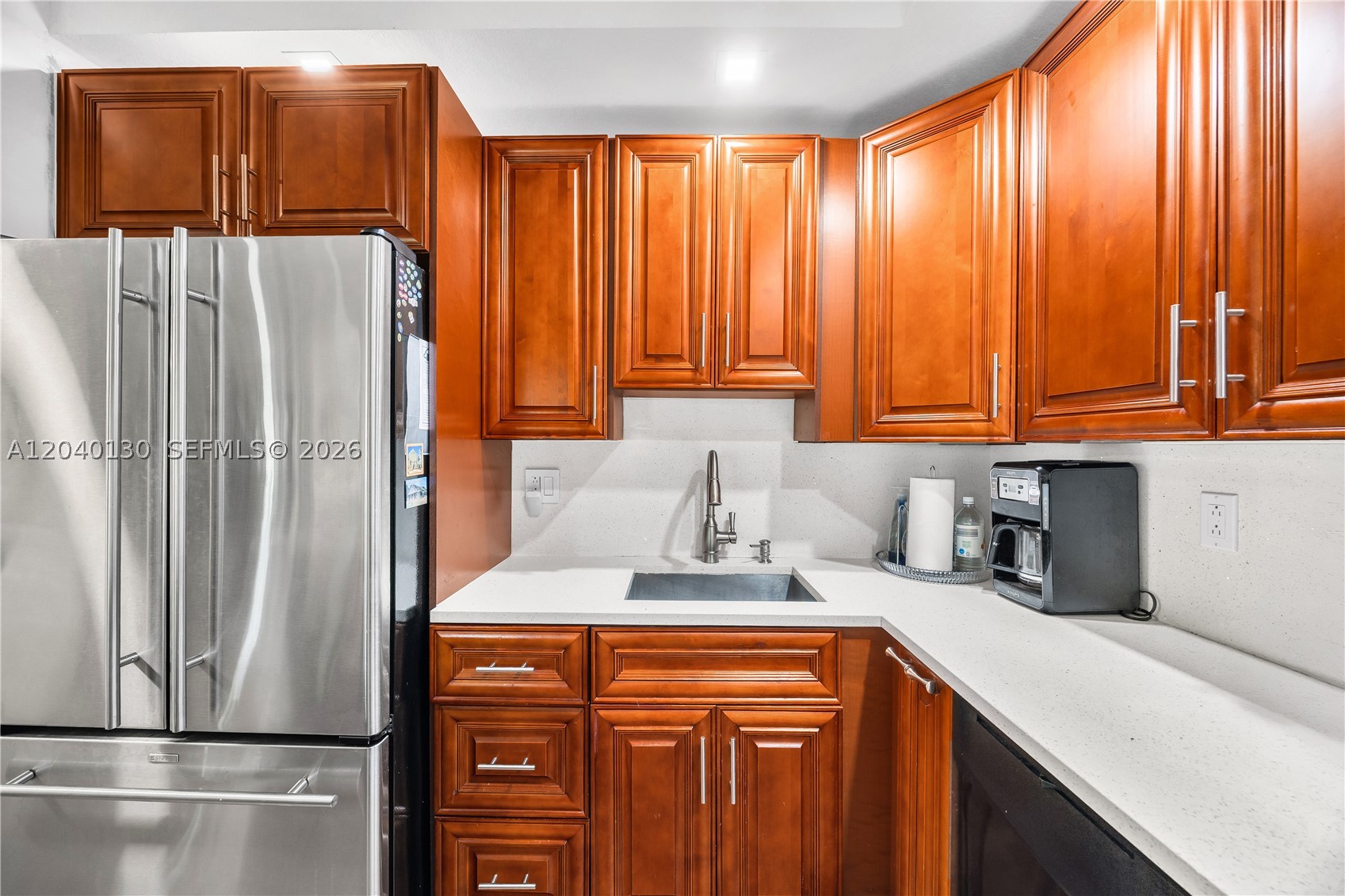 Beautiful lakefront corner unit in Kings Point's Belfort community! This 2-bedroom, 2-bath residence features a versatile den, ideal for a third bedroom, guest space, or home office. The remodeled open-concept kitchen flows seamlessly into the dining and living areas, creating a bright and inviting space that extends to a screened balcony overlooking serene lake views.

The spacious primary suite features an oversized walk-in closet, and the unit also includes a full-size in-unit washer and dryer for added convenience. Additional upgrades include complete impact windows throughout, a 2009 Rheem A/C system, and a 2022 tankless water heater.

Belfort is a 24-hour gated community with security and resort-style amenities, including indoor and outdoor heated pools, card rooms, a theater, arts and crafts studios, fitness center, tennis courts, pickleball, courtesy shuttle service, and a vibrant calendar of social events.

The monthly maintenance includes water, internet, cable, and pest control, providing exceptional value and convenience. Ideally located near shopping, restaurants, major highways, and hospitals, this home offers the perfect blend of comfort, lifestyle, and location.