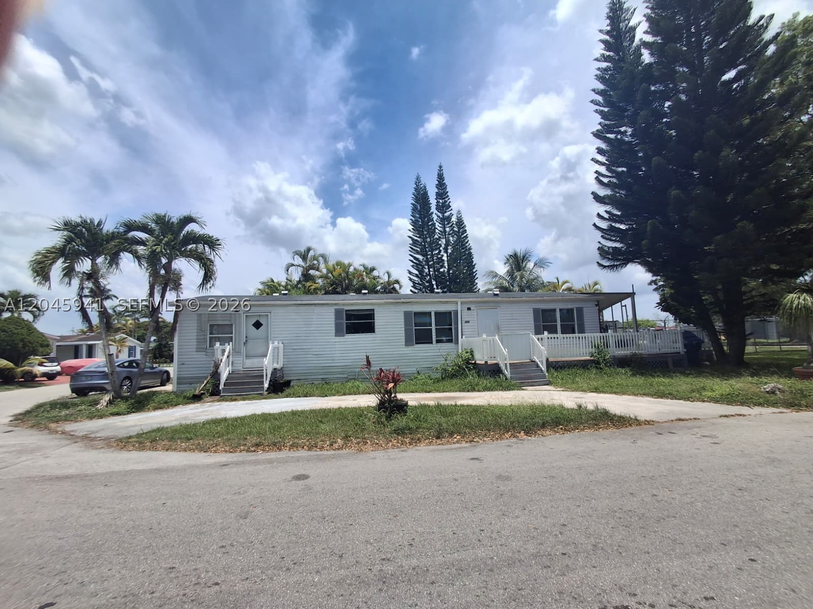 Welcome to Americana Village, a sought-after gated community tucked along Krome Avenue in Miami’s peaceful Redland area. Great opportunity to own the lowest-priced 3-bedroom home currently available in the community! This 3-bedroom, 2-bath double-wide manufactured home offers 1,430 sq ft of living area and includes both the home and the land. The home is a fixer-upper with great potential for buyers looking to renovate, personalize, and build value. Features include an interior washer and dryer, parking for up to 4 vehicles, and a spacious layout with room to make it your own. Low monthly maintenance fee of only $163 includes water and trash. Americana Village offers a true neighborhood feel with amenities including 2 pools, clubhouse, basketball courts, playground, 24/7 security, and a guarded entrance. Enjoy the charm of Redland living, surrounded by open skies, nurseries, fruit stands, farms, parks, and local favorites such as Knaus Berry Farm, Fruit & Spice Park, Castellow Hammock Park, Mango Cafe, and Krome Brewing Company. Conveniently located near Publix, everyday shopping, dining, and major roadways, this property offers an affordable opportunity to enjoy a quieter South Miami-Dade lifestyle while staying connected to city conveniences.**Cash or Hard Money only*** Please submit offers through the property’s listing page on www.auction.com/privateseller