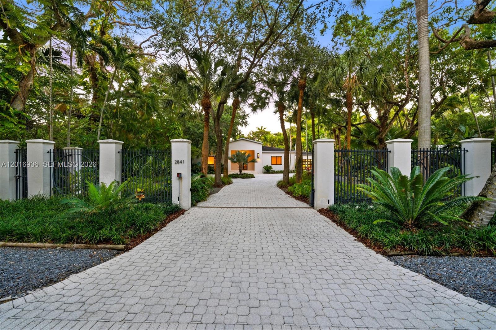 Exceptional half-acre estate in one of Coconut Grove’s most coveted blocks. 4-bed, 4.5-bath 4,531 total sq.ft. single-story contemporary fully renovated in 2020 w/ all-new electrical, plumbing, HVAC, roof, finishes, Italian Lualdi divider & Italdoors interior doors. French oak hardwood open plan w/ expansive Leicht German chef’s kitchen—premium Thermador appliances incl. 2 ovens & Taj Mahal counters—great for cooking & entertaining. Marble master bath w/ Japanese ofuro soaking tub, walk-in rain shower & dual vanities. Hurricane-impact doors & windows. Natural stone patio w/ pool under lush canopy, fully fenced. High-ceiling 2-car garage w/ glass doors, windows & circular gated driveway. Professionally landscaped. Lightly used as second home. Zoned for up to 10,000+ SF future expansion.