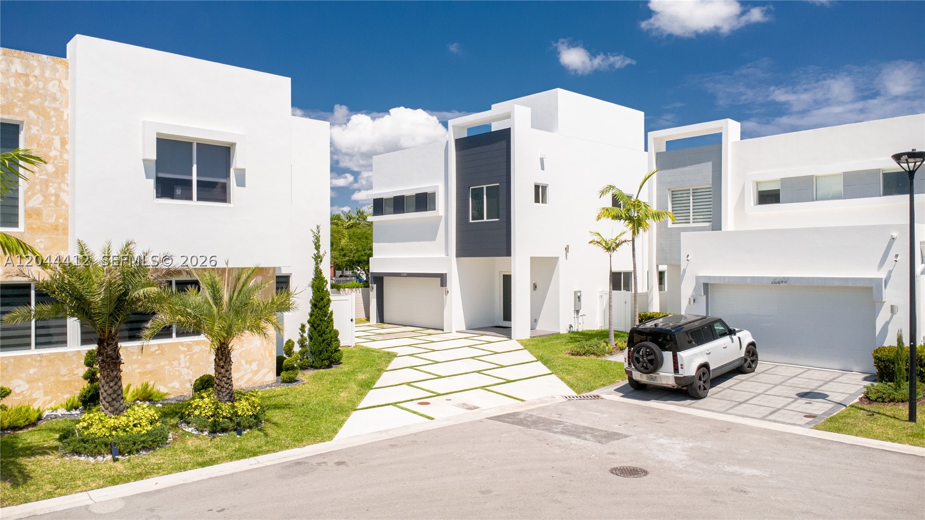 Brand-new luxury residence in the exclusive gated community formerly known as Neovita, now rebranded as ICON Estates—one of Doral's most prestigious and luxurious communities. This stunning contemporary home offers 5 bedrooms, 4 full bathrooms, including a first-floor guest suite with a private bath. Bright open-concept layout with soaring ceilings, elegant finishes, and seamless indoor-outdoor living. The expansive terrace is ideal for entertaining, featuring ample space for a summer kitchen, lounge, and outdoor dining overlooking the pool. Spacious driveway accommodates up to 6 vehicles, plus a 2-car garage. Residents enjoy resort-style amenities, including a clubhouse, fitness center, swimming pool, jacuzzi, children's playroom, and beautifully landscaped common areas. Prime location near top-rated schools, major highways, shopping, dining, and Miami International Airport. A rare opportunity to own a brand-new home in one of Doral's premier luxury communities