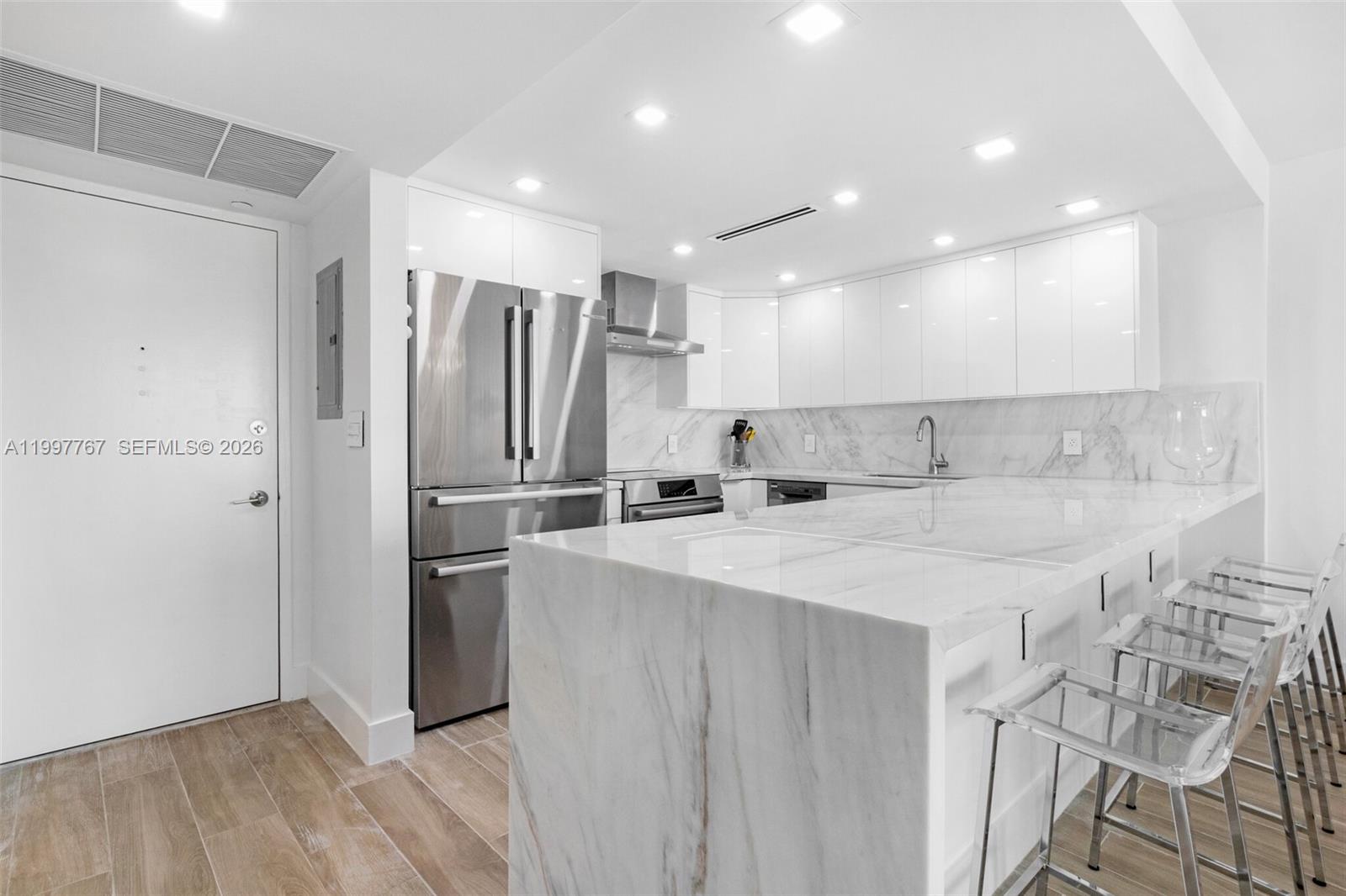 Experience elevated Ocean Front living in what may be the best one-bedroom plus Den residence in the community. This lower penthouse on the 17th floor has been substantially renovated with impeccable attention to detail, featuring a stunning kitchen with waterfall-edge countertops, premium Bosch appliances, and sleek, seamless cabinetry.  The residence showcases beautiful wood-look porcelain flooring throughout, combining warmth and durability with a high-end finish. Both bathrooms have been tastefully remodeled, and the spacious layout offers exceptional closet space and functionality.  Enjoy peace of mind with impact sliding glass doors and impact windows, while the generously sized west-facing balcony captures breathtaking sunsets over the Intracoastal, with distant views extending toward the golf course and bay.  Offered turnkey with furniture, this is a rare opportunity for effortless move-in or investment.  Located in a full-service oceanfront building with direct beach access, residents enjoy resort-style amenities including complimentary beach service (2 chairs & umbrella), oceanfront pool, fitness center, on-site dining, salon, 24-hour concierge, and valet. The unit also includes a highly desirable assigned covered self-parking space.  
A true standout in Mid-Beach—style, comfort, and location all in one.