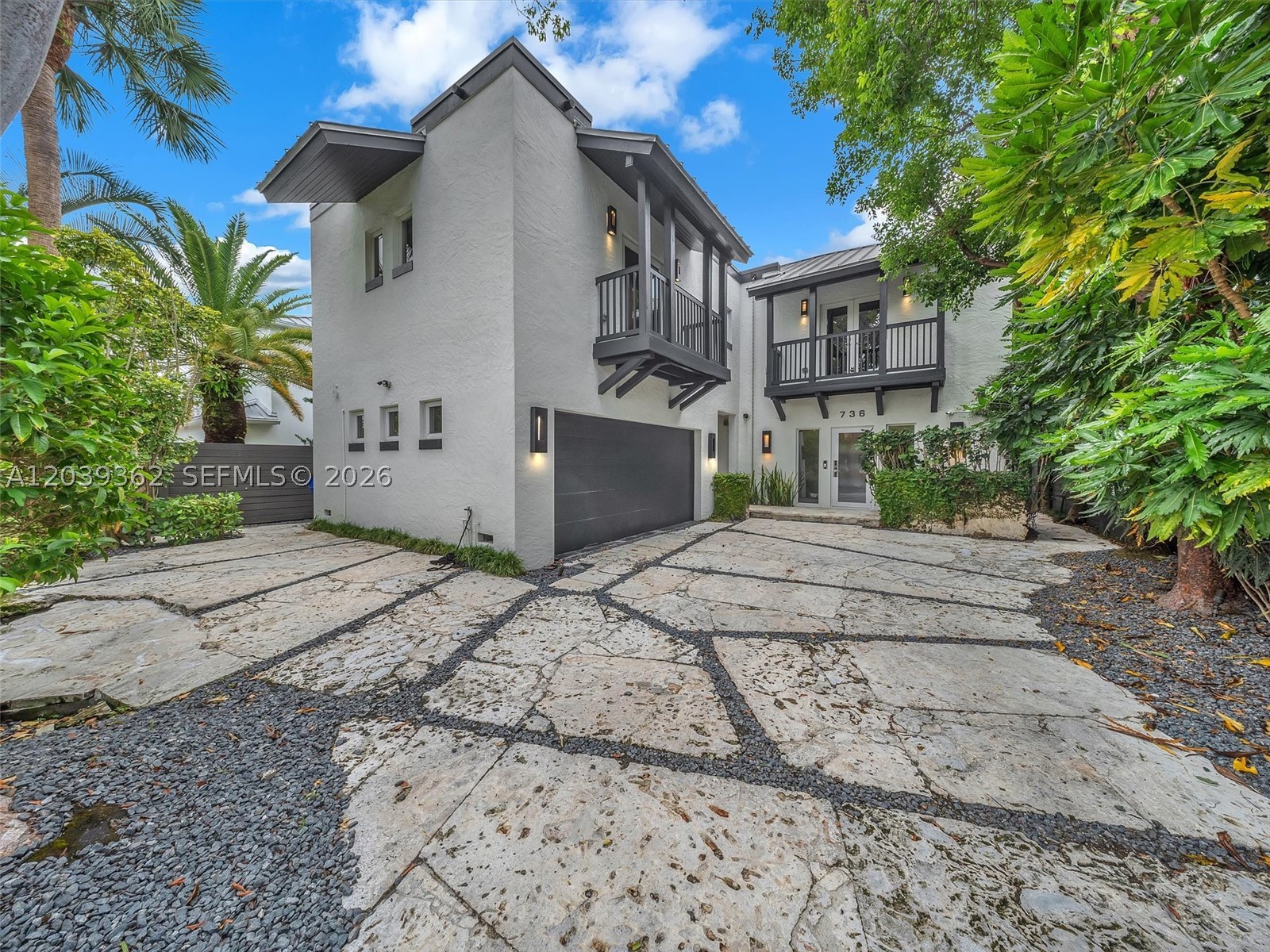 Welcome to the heart of Victoria Park—one of Fort Lauderdale's most coveted neighborhoods. This stunning two-story home offers 4 bedrooms, 3.5 bathrooms, and over 3,000 sq ft of living space. A coral stone driveway creates a warm arrival, while impact windows and doors provide beauty and peace of mind. The open-concept floor plan connects living and dining areas with wood flooring, natural light, and timeless finishes. The kitchen features a KitchenAid gas range/oven, Wolf wall oven, microwave with warming drawer, built-in refrigerator, two sinks, cabinetry, and a nook. A custom bar room with wine cooler and ice maker is perfect for entertaining. Upstairs, all four bedrooms have hardwood floors and ceiling fans. One includes a built-in workspace, another an ensuite bath and balcony. The primary suite has two separate French doors to private balconies and a spa bath with dual vanities, soaking tub, and walk-in shower. The backyard features a heated saltwater pool and spa, waterfall, outdoor fireplace, pergola, summer kitchen with grill and ice maker, putting green, and tropical landscaping. Also includes a whole-house gas generator and air-conditioned 2 car garage. Minutes from Las Olas (downtown),  beaches, Holiday Park, dining, and shopping—Victoria Park living at its finest.