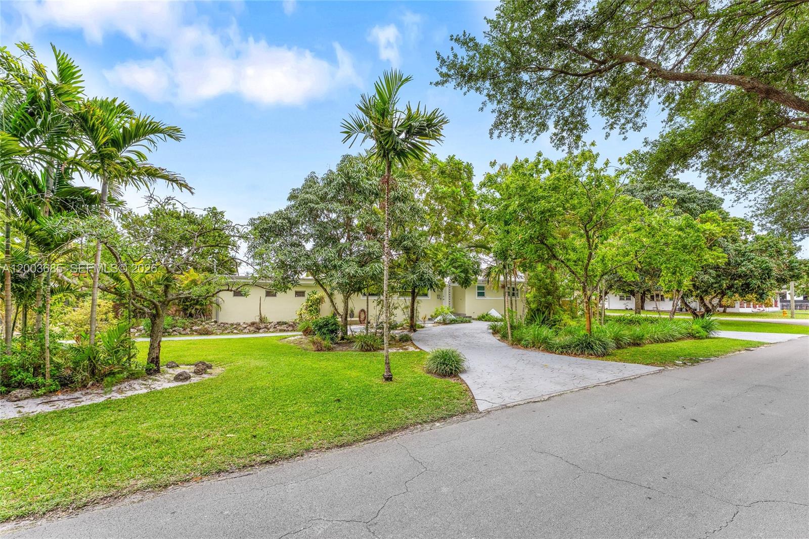 Welcome to 501 Lawn Way in Miami Springs, a beautifully maintained residence where timeless character meets thoughtful upgrades and effortless South Florida living. Offering 1,882 square feet of interior space and 2,266 total SF, this 3-BR, 2-BA home is designed with both comfort and flexibility in mind. A versatile extra room provides the perfect opportunity for a private in-law suite, guest retreat, or conversion into a spacious primary suite—tailored to suit your lifestyle. At the heart of the home, the kitchen features rich wood cabinetry paired with granite countertops, creating a warm and functional space ideal for both everyday living and entertaining. Set on an expansive 10,225 square foot lot, the property offers exceptional outdoor potential, including side fenced parking ideal for boat storage—a rare and valuable feature. Four mature mango trees enhance the setting, bringing a touch of tropical charm to your private outdoor space. A covered carport adds everyday convenience and protected parking. Key upgrades provide lasting value and peace of mind, including hurricane impact windows, a roof replaced in 2013, and new gutters installed in 2025. Ideally located in one of Miami’s most sought-after residential enclaves, residents enjoy tree-lined streets, distinctive architecture, and a true sense of community—all just moments from the best of Miami. A refined opportunity offering space, flexibility, and lifestyle - set within the enduring charm of Miami Springs.